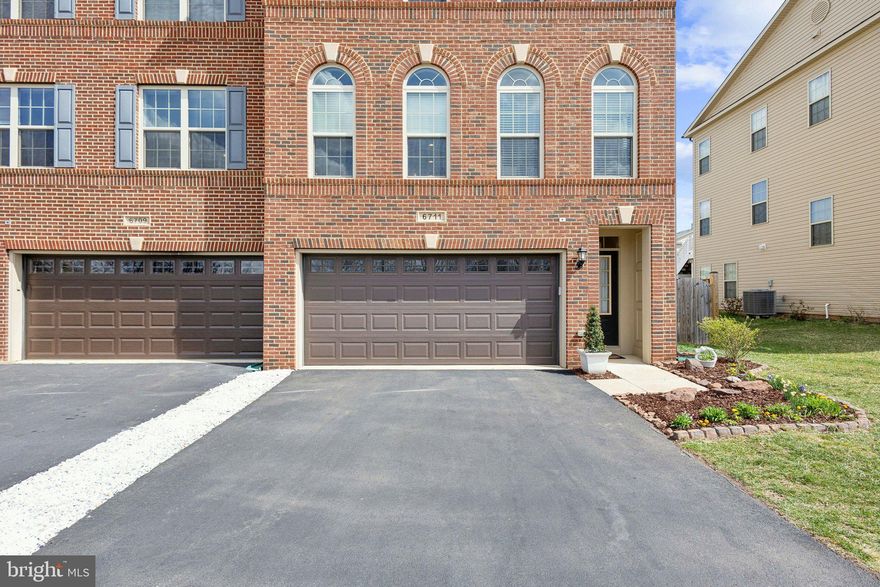 Welcome to 6711 Pinchot Lane, Haymarket—a beautifully upgraded end-unit Paxton Model with 3,435 sq. ft. of elegant living space. Situated on one of the best lots in the community, this home offers unobstructed front and back views, a manicured courtyard, and mountain and pond views from the front.  

Inside, natural light floods the open-concept main level, where upgraded hardwood floors complement the gourmet kitchen with custom soft-close cabinetry, an 11-foot granite island, Whirlpool appliances, and a double oven. The family room features a gas fireplace, and French doors lead to a spacious Trex deck with a lighted staircase and fenced yard below. A private home office with French doors provides the perfect work-from-home space.  

Upstairs, the primary suite is a true retreat with a tray ceiling, two walk-in closets, and a spa-like bath featuring an extra-large soaking tub, upgraded tile, and dual granite vanities. Two additional vaulted-ceiling bedrooms, a full bath, and an upper-level laundry closet complete the floor.  

The lower level offers new laminate flooring, a full bath, and walkout access to the backyard and two-car garage. Recent updates include a brand-new HVAC system (2024), new dishwasher (2024), resurfaced driveway, and cordless blinds throughout.  

Located in amenity-rich Villages of Piedmont II, with an HOA of $182/month, enjoy a clubhouse, pool, tennis courts, dog park, and over eight miles of scenic trails. A playground is just steps away, with shopping, dining, and UVA Hospital minutes from your door. Easy access to I-66 and top-rated schools, with a bus stop at the end of the street.  This move-in-ready home is a rare find.