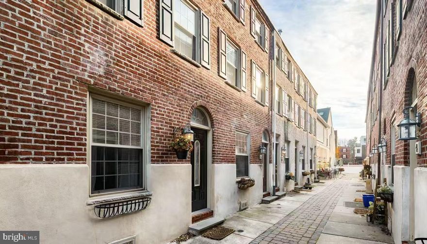 Welcome to Abbott’s Court, an intimate gated courtyard community of just 15 homes, perfectly situated in the heart of Queen Village. This expanded trinity home offers 2 bedrooms and 1.5 baths, combining charm, functionality, and an unbeatable location. Enjoy the best of city living with a peaceful, tucked-away setting—just steps from Center City, South Street, Society Hill, Washington Square, Passyunk Avenue, and Headhouse Square. Top-rated Meredith School catchment and pet-friendly living make this home even more desirable.
Enter into a freshly painted, open-concept living and kitchen area featuring hardwood floors throughout. The kitchen is thoughtfully designed with stainless steel appliances, beautiful wood cabinetry, and upgraded countertops. A stylish half bath completes the main level. Just off the kitchen, a private outdoor space provides convenience for trash, recycling, and bike storage.
The second floor features a spacious bedroom with hardwood flooring, a walk-in closet, and an ensuite full bath complete with a whirlpool tub/shower combo—perfect for guests. The third-floor primary bedroom is filled with natural light and cozy carpet and a walk-in closet, creating a bright and comfortable retreat.
The unfinished basement includes a washer and dryer and provides excellent storage space. The home also features updated exterior stucco (2021) for added peace of mind.
Abbott’s Court offers a beautifully maintained shared courtyard with propane grills, bike racks, and patio seating—ideal for relaxing or entertaining. The gated community includes intercom access from Fitzwater, Bainbridge, and 6th Street, allowing convenient entry for residents and guests.
Located just minutes from the Italian Market, Whole Foods, Acme, top restaurants, gyms, and public transportation, this home delivers exceptional walkability and convenience.
If you’re looking to enjoy vibrant city living while maintaining privacy and tranquility, this is the one. Don’t miss this opportunity—schedule your showing today!