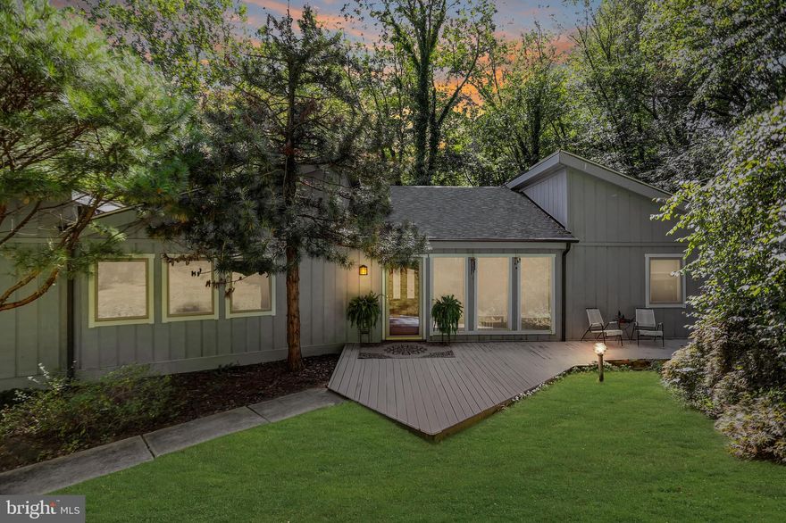 Contemporary raised rancher situated on a hillside and surrounded by trees. Open floor plan with vaulted ceilings and skylights. Living room features a cozy seating nook in front of the fireplace and has sliders to the deck overlooking the trees. The deck wraps around to the dining room which has sliders ,a large window, fireplace and wood floors. From there you can pass through to the kitchen to a casual living space with a wood burning stove. This space adjoins one of the bedrooms  that has a closet and walk-in entry to the attic storage area. On the other side of the main floor is the primary bedroom that features it's own deck and has an ensuite bathroom. There's also another bedroom and full bath with shower on this side of the home. The lower level is completely finished to include a family room with it's own fireplace plus two additional rooms each with sliders to the back patio. There's also a full bathroom and laundry room as well as the interior entry to the two car garage. One year home warranty included for Buyer at settlement. Roof and gutters new in 2020. Price is reflective of need for cosmetic updates and some routine maintenance items. Great opportunity to personalize and make this home your own.