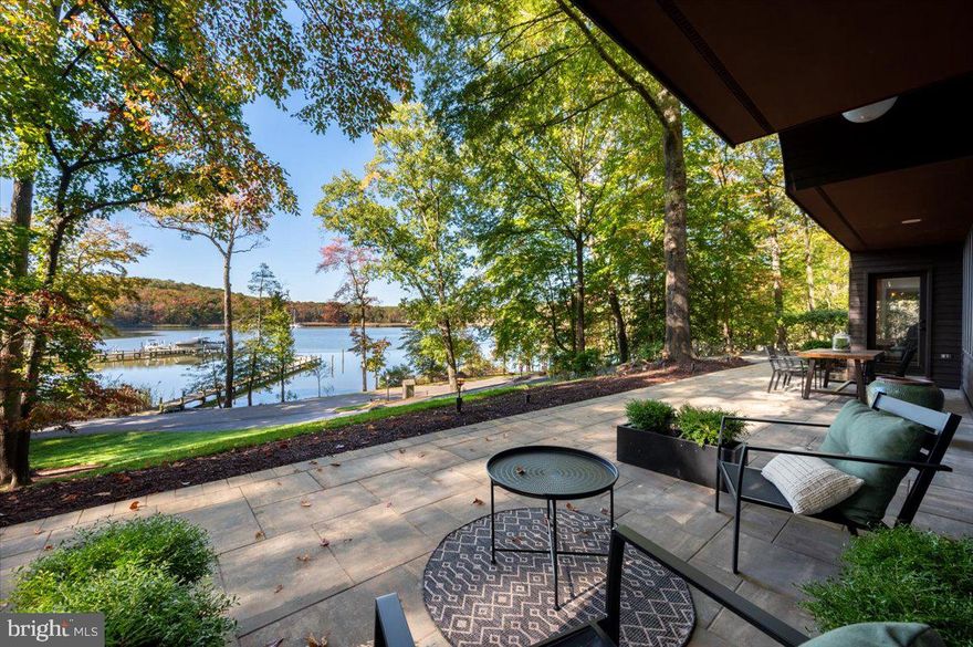 Experience luxury waterfront living in this stunning contemporary home, featuring expansive water views from every room.  Enjoy an open floor plan for all of your hosting and entertaining needs.  The home is bathed in natural light, thanks to floor-to-ceiling windows that seamlessly blend indoor and outdoor spaces.  Step outside to the massive paver patio perfect for entertaining or enjoying the water views.  With western exposure, there are gorgeous sunsets every evening.  It's the perfect time of year to cozy up to the new masonry, wood burning fireplace with stone facade in the living room!  Everyone in the family can have the "best" room since all four bedrooms have a water view.  Retreat to your primary suite with private deck overlooking the water and completely remodeled ensuite bath including stand alone soaker tub, walk-in shower and two sinks.  Bedroom 2 also has a completely remodeled ensuite bath.  Head to your private pier for an evening cruise on the Severn River or for a fun-filled day, venture out to the Chesapeake.  You must see this home to truly appreciate its beauty!
There have been so many thoughtful and timeless renovations executed on this home in the past year, including: 
Entire 2nd level has new hardwood floors, solid wood doors and closet doors, new baseboards and casings. 
New LED lighting and recessed lighting added on 2nd floor
New electric black-out shades in the primary bedroom
All new interior paint
Refinished floors on the main level
All new ceiling fans
Complete new sod installed