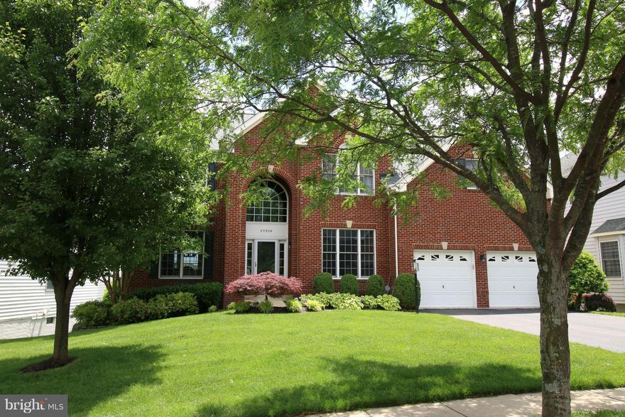 Beautiful home on South Riding Golf Course!  Artist owned!  Wood floors throughout, stone fireplace, soaring ceilings.  Updated gourmet kitchen with table and bar space.  Updated baths.  Raised ceilings in LL with separate living spaces, bedroom and bar.  Huge deck and patio in rear overlooking the pond, fairways and green.   Entertaining dream!