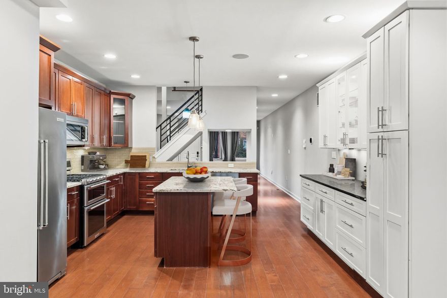 Experience contemporary city living in this 4-bedroom, 3.5-bath townhome in the heart of Graduate Hospital, offering approximately 3,000 square feet across four levels. The home features four private outdoor spaces, including a  roof deck with skyline views, and the option of a leased parking space included for two years with an acceptable offer.
The main level offers an open-concept layout with high ceilings, abundant natural light, built-in surround sound, and a gourmet kitchen. No detail was overlooked, with stainless steel appliances, granite countertops, a large island with seating, and a built-in beverage refrigerator. The dining area opens to a landscaped rear patio with a custom wood trellis.
The second floor includes an ensuite bedroom, two additional bedrooms (one with access to a large deck), a hall bath, and laundry. The entire third floor is dedicated to the primary suite, featuring a walk-in closet, spa-like bath with jetted tub, glass shower, double vanity, and a private deck just off the wet bar. 
Additional highlights include a finished lower level with flexible living space, dual-zone HVAC, reverse osmosis water filtration, whole-house surround sound, and a roof replaced in 2023.
Located just minutes from South Street West, the PHS Pop-Up Garden, Avenue of the Arts, and Rittenhouse Square, with dining, shopping, and transit nearby. Reach out to schedule a private tour!