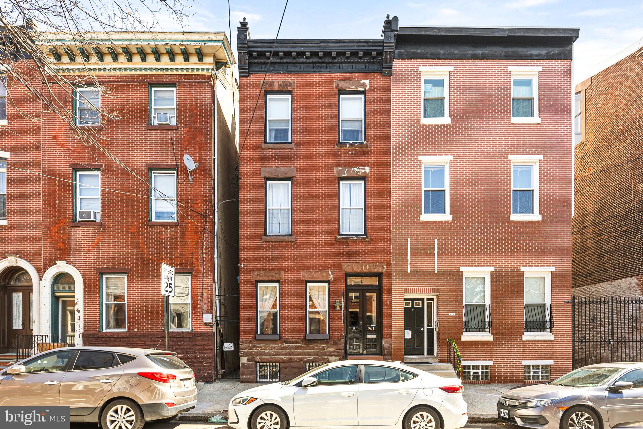 A perfect fusion of historic charm and modern sophistication, this distinguished Northern Liberties townhouse offers a truly elevated living experience. Enter through an exquisite vestibule with double doors adorned in playful wallpaper, setting the tone for the home’s unique character.
The living room is a sanctuary of timeless elegance, featuring expansive windows that bathe the space in natural light, original wood flooring with intricate inlays, exposed brick walls, custom built-ins, and soaring ceilings that enhance the sense of grandeur. Beyond the living room, the open dining area seamlessly flows into the chef-inspired kitchen, bathed in natural light from generous windows.
The kitchen has been meticulously renovated with sleek quartzite countertops, a convenient breakfast bar, top-of-the-line stainless steel appliances, and heated tile floors. A separate bar area adds a touch of refinement, perfect for entertaining. Adjacent to the kitchen, a versatile bonus room or office space provides ample room for work or relaxation, with a conveniently located powder room.
Step through sliding glass doors to an outdoor oasis—an inviting patio area with brick pavers that overlooks an expansive, meticulously manicured lawn, offering a peaceful retreat in the heart of the city.
On the second level, the spacious primary suite provides an exceptional private sanctuary. The bedroom features bay windows, a cozy sitting area, and a private covered patio. The suite is completed by a walk-in closet and an opulent bathroom, featuring a double marble vanity, heated marble tile floors, a seamless glass shower, and a luxurious soaking tub—a perfect escape.
Also on this level, a light-filled guest room features the home’s original built-in vanity, adding a touch of historic charm.
On the third floor, a generous bedroom awaits, along with an oversized hall bathroom that includes a classic clawfoot tub with shower, a double vanity with a marble top, and a full-size washer and dryer for convenience.
This home also offers a semi-finished basement and a large storage room, providing ample space for all your needs. Experience the perfect blend of historic beauty and contemporary luxury in this extraordinary Northern Liberties gem.