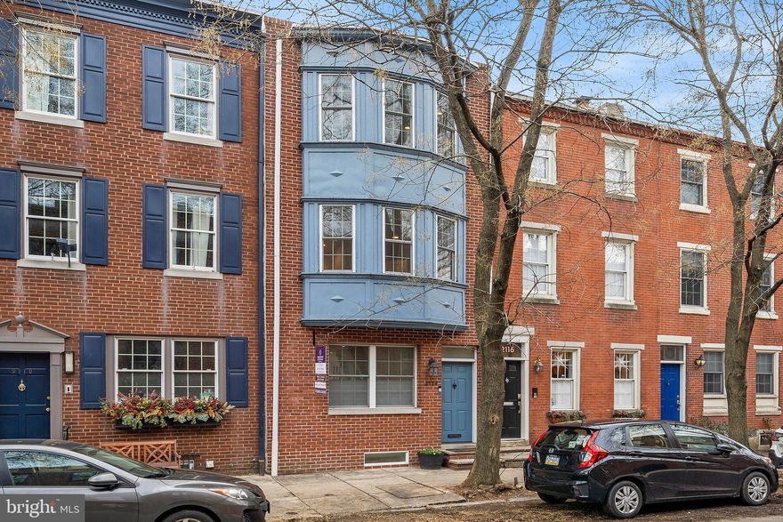 Welcome home to this one-of-a-kind property in the heart of Fitler Square in GREENFIELD school district loaded with upgrades and amenities! This 4 bedroom, 2.5 bath home runs STREET TO STREET with 1 CAR PARKING (possibly two) in the rear which gives you the most optimal layout! There are approx. 5 years remaining on the TAX ABATEMENT (renovation) as the property was fully renovated and expanded in 2016 by the current owner, a real estate agent and developer, for their family. Before walking through the front door, you are greeted by a beautifully restored two story bay window and an all new brick facade.  Wide open, perfectly situated, floor plan includes a living room with gas fireplace option and brick surround, dining room, and enormous kitchen with 8 ft island! Tall ceilings throughout (9 -10 ft) on each floor and 8 ft in the finished basement! Gorgeous 7 inch wide plank natural white oak hardwood floors throughout! Designer kitchen has it all, including beautiful Omega Dynasty cabinetry (white shaker), stainless steel appliance package (GE CAFE), superwhite quartzite countertops, Jenn-Air drawer microwave, wine refrigerator, pot filler, and an enormous 9 ft tall pantry! Tons of natural light throughout the home, especially on the first floor due to two large front windows and an entire wall of windows in the back (south facing) including two full glass Pella French doors leading out to the large brick paved back patio. The second floor has two bedrooms including the owner's suite and guest room/office/nursery. Owner's suite consists of a spacious bedroom, large walk-in closet fully outfitted with a custom closet system, and a beautiful marble bath including a soaking tub, large shower with marble tile and rain head shower system and double vanity with white marble heated floors. Third floor is also optimally designed which includes two additional large bedrooms, a hall bath with double vanity and Kohler tub, and a large laundry room with full size LG washer and dryer plus cabinetry, countertops and sink! Dry bar on 3rd floor which helps service the FULL ROOFDECK with breathtaking panoramic city views (and treetops on Lombard Street!). Don't miss the FINISHED BASEMENT with heated tile floors and powder room for that valuable extra living space! This home truly has it all! Additional upgrades include:  Pella windows throughout, new basement tile 2021, Nest/Ring smart home technology, solid core two panel interior doors, roll up garage door in rear with keypad, gas line for fireplace in living room and basement, closet systems in all bedroom closets, all bedrooms wired for cable, custom Hunter Douglass blinds on every window, oversized undermount kitchen sink, West Elm dining room chandelier, upgraded plumbing fixtures, upgraded vanity lights and mirrors, and more! GREENFIELD SCHOOL DISTRICT!