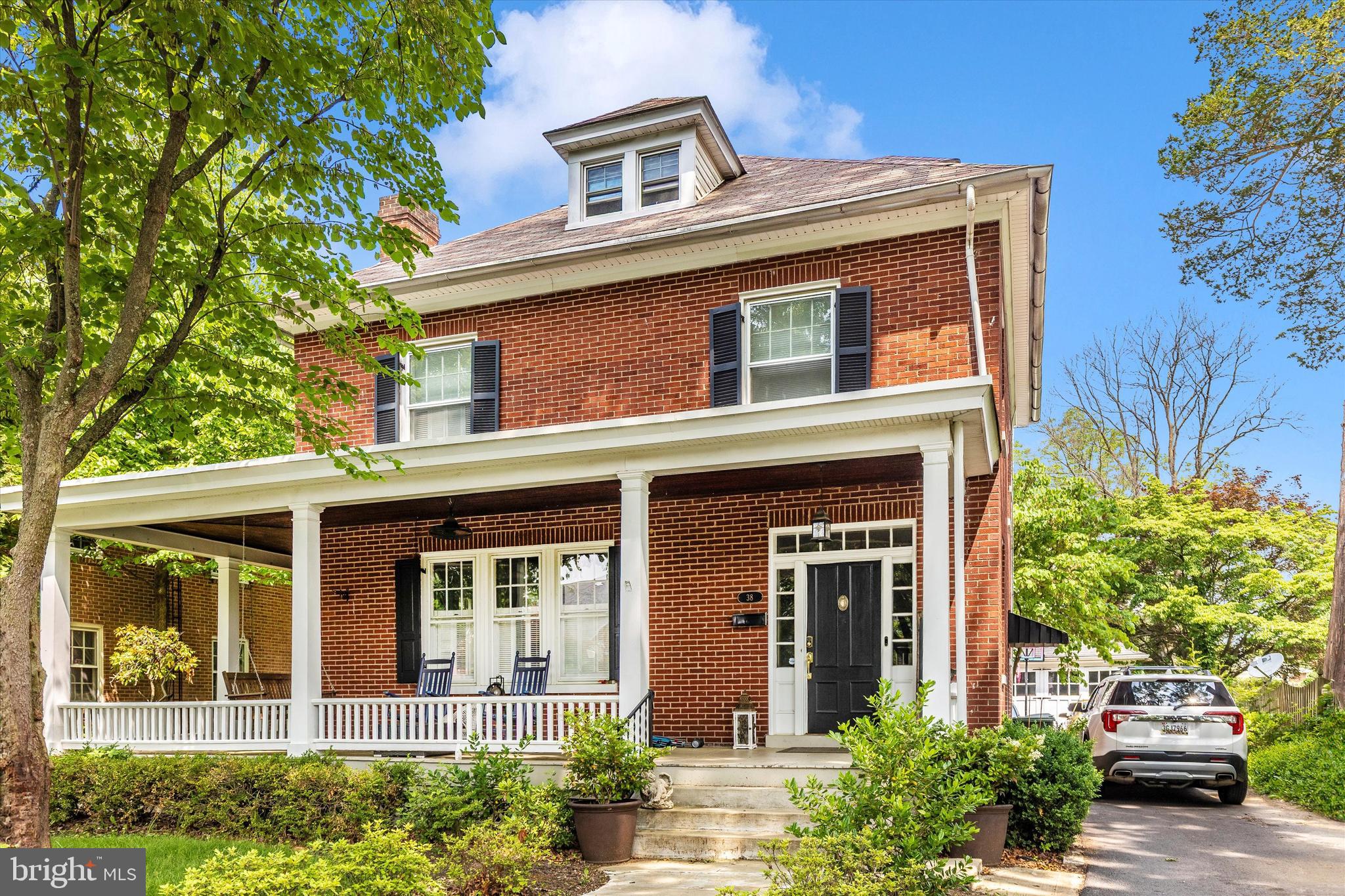Gorgeous brick Colonial in the North End with a covered wrap around front porch! Walk into your spacious foyer with natural oak hardwood flooring & a stunning staircase. Living room with wainscotting molding and a gas fireplace. Kitchen recently remodeled with custom 46' cabinets with crown molding, granite countertops, stainless steel appliances & recessed lighting. Breakfast table off the kitchen for informal meals with a sliding door to a covered back porch which is great for indoor/outdoor entertaining. Family room with a 2nd gas fireplace with custom shades & built in bookcases. Main level fully remodeled full bathroom. Upstairs you have 4 bedrooms and a 2nd fully remodeled bathroom. Attic is fully finished with a 5th bedroom. Detached garage. The current owner put in over 200K into making this house perfect for the next owners. Great location close to shopping, restaurants & major highways.