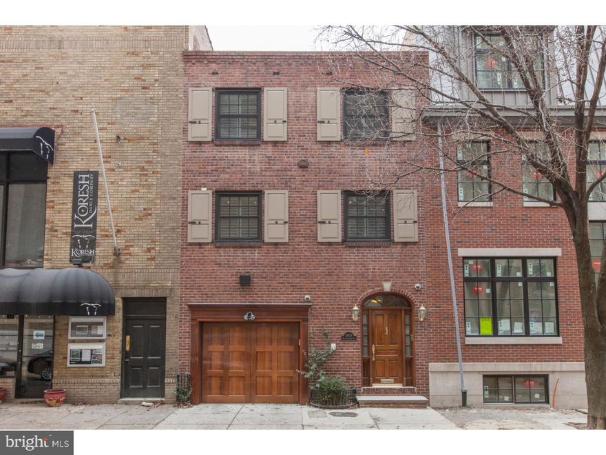 Welcome to Rittenhouse Square living at its best! This very RARE and beautiful 21-foot wide town house sits on a quiet block just steps from Rittenhouse Square Park with GARAGE parking! Enter through the custom-made African mahogany door into the first floor foyer, featuring oak hardwood floors that extend to a large 1st floor bedroom with functional wood burning fireplace, full bath, stacked washer/ dryer, spare refrigerator and a back den / office area with sliding Morgan doors that exit to a patio area.  The 1st floor bedroom could be ideal for an in-law suite.  The office/den has been fitted with plumbing, perfect for converting into a kitchen.  The 2nd floor features an updated kitchen and a huge, spacious living room and dining room with custom inlay hardwood floors with an open floor plan, a wood burning fireplace, and two doors that open to a large composite deck with a retractable awning, gas grill with oven, perfect for outdoor entertaining rain or shine! The 3rd floor boasts two spacious bedrooms.  The master bedroom features a wood burning fireplace and en-suite bathroom with frameless glass shower door, Pfister fixtures, marble tiles and heated floors.  The other 3rd floor spacious bedroom features a marble bathroom also with heated floors and Pfister fixtures.  The home has a Rennai tankless water heater; built-in surround sound speakers throughout, including on the second floor deck; Hunter Douglas shutters; classic red brick front; spacious rooms; tons of storage; modernized Anderson windows; garage; three functional fireplaces; it's outfitted with four security cameras; and, much more!  The house is zoned for a fourth floor addition? architectural plans were created for the fourth floor addition, which include an elevator.