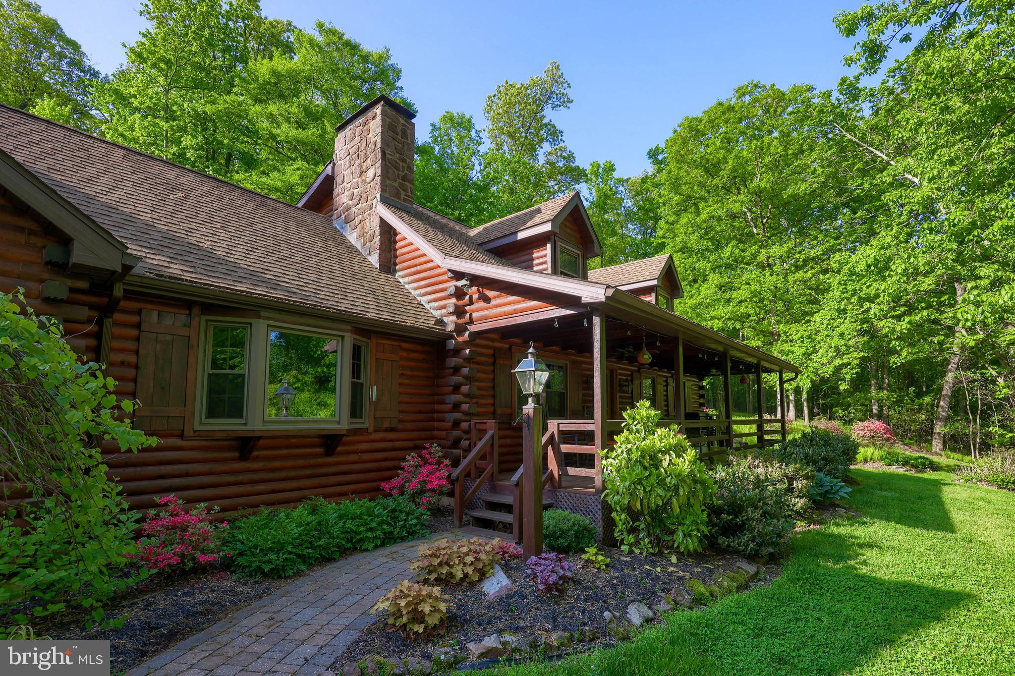 Beautiful, Secluded Custom Red Cedar & Pine Log Home with 2 car detached garage. Detached 3 car garage and heated shop on 13.66 acres. With approx. 2,900 sq. ft., this home is a masterpiece of pegged wooded floors, exposed beams, stone fireplaces, cathedral & vaulted ceilings, skylights and so much more! A wet bar in the fully finished basement to entertain. A beautiful covered porch and exterior bonfire area. This home has 3 heating options of wood burning, fuel burner, or electric heat pump with AC. Beautiful manicured flower beds and trees. This property is next to the famous French Creek State Park and The Historic Johanna Furnace. Bring your horses. Come see this magnificent property while it is available! This home comes fully furnished. All home furnishings and décor will stay!