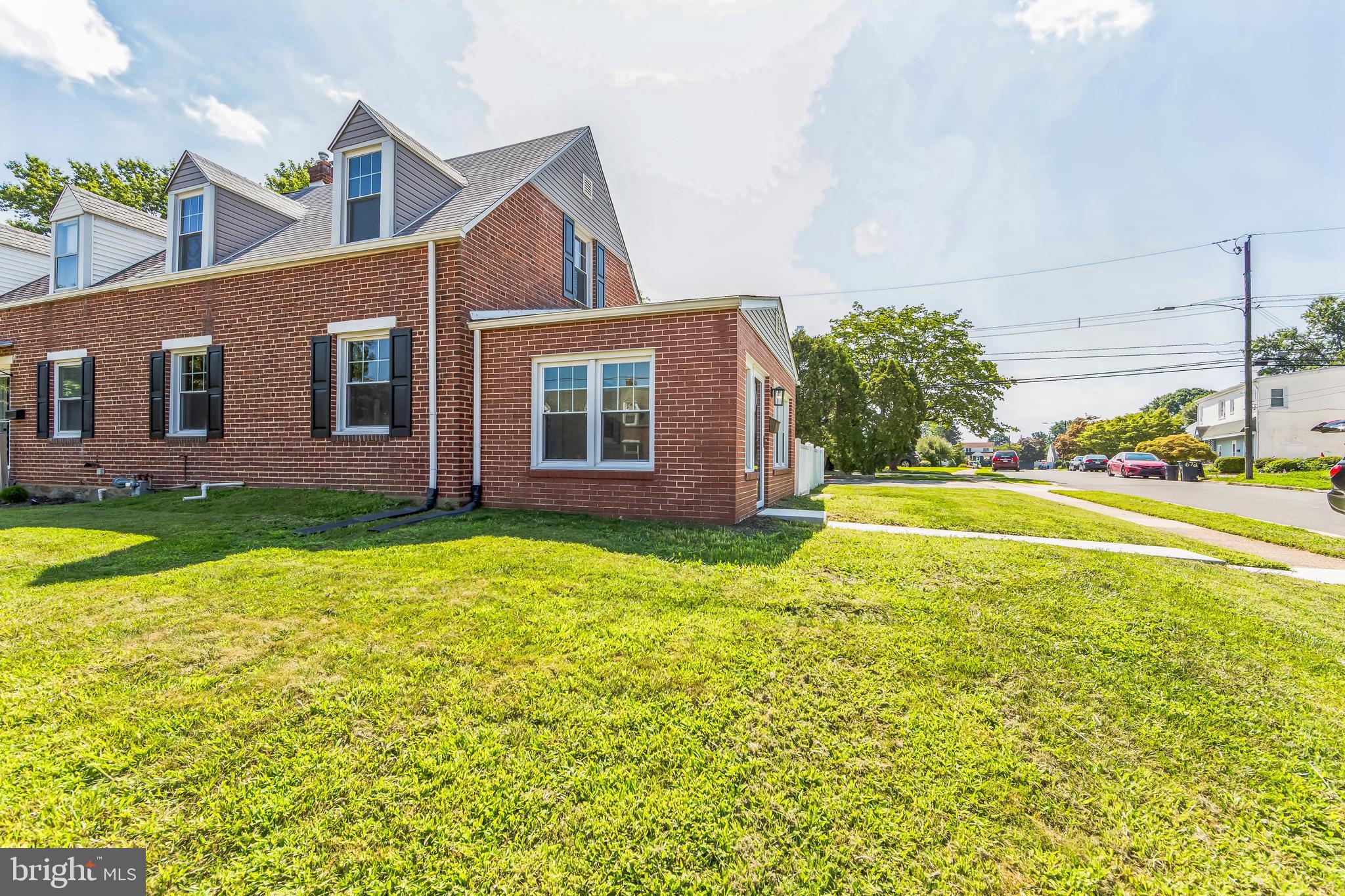 This brick cape cod home is a real charmer! 2 bedrooms and 1 bath with another room w/ closet in basement. Also in the basement in your utility room/ laundry room you have a utility sink and a toilet- upstairs on the main level -freshly refurbished hardwood floors throughout and a fully renovated interior, you've got the best of elegance and modern comfort. The bright sunroom adds additional square footage and practically begs for cozy mornings or lush houseplants. Also a finished lower level. And those appliances? All new including fridge, dishwasher, gas stove, built in microwave, plus a washer and dryer. Total win for convenience. The fenced yard and patio add an outdoor appeal. Plus offstreet parking for two cars.