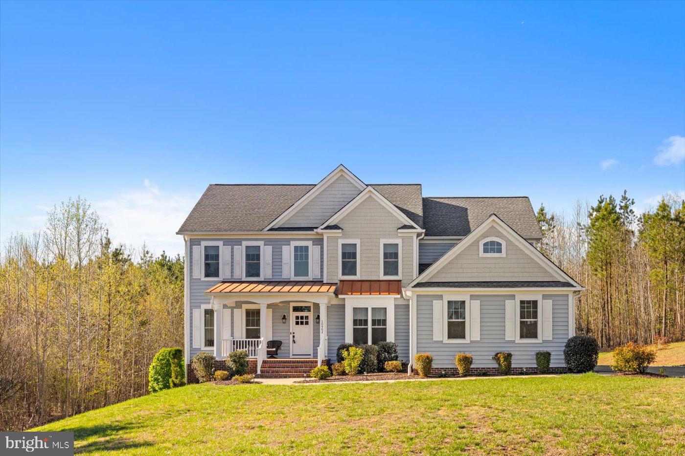 Opportunities to own in Fortunes Landing at this price point are exceptionally rare! This cherished Thomas floor plan by Simply Home presents a unique moment for the discerning buyer to experience the prestige, privacy, and elegance of one of the area’s most sought-after estate communities—without surpassing the million-dollar threshold. Assumable Loan for Qualified Buyers! 3.25% interest rate! 10902 Downton Avenue is truly as wow-worthy as it gets, folks! The classic colonial includes four bedrooms (plus, a possible fifth NTC!), 4.5 baths and nearly 4,900 square feet of living space. The acreage here is as serene and scenic as it gets. A lengthy asphalt driveway segues to the homesite, which is well-tucked off the road. The front yard is expansive, green, low-maintenance and peaceful. From its front porch or just inside, you can watch teacup roses bloom and, come daily sunrise time, a lovable deer family and rabbits frolic in the expanse. For parking there is a side-loading, three-car garage with an intricate Flow Wall organization system and refrigerator that convey. The back yard backs up to woods for added privacy. Its undeniable anchor is a vast Trex deck and slate patio with a firepit. For grilling, there is a gas grill that conveys right there! The residence itself pops with baby blue and beige siding as well as copper-esque roofing elements, architectural shingles and gutter guards. Stepping inside, the home is inviting, open and non-linear with tasteful spaces for entertaining and everyday life aplenty. Highlights include the entry foyer with a medallion anchored chandelier; a carpeted office/study; the formal living room with built-in bookcases and benching; (the sunrises from here are stunning!); the large formal dining room with a tray ceiling and extensive crown molding accents; and the kitchen. The kitchen includes a massive island, neutral soft-close cabinetry, white subway backsplash tiling, stainless steel Whirlpool appliances (note the smart double oven!), granite countertops and a built-in wine rack! Off the kitchen is a mudroom with built-in cubbies and a sink. Also off the kitchen is breakfast room as well as the spacious carpeted family room, complete with gas fireplace and windows for taking in the most perfect of sunsets. Upstairs (note that awesome black wrought-iron staircase!) you’ll find four bedrooms and three full baths. The primary suite is enormous with an adjacent sitting room (this may easily be a prime office or home gym area!). Also within the primary suite is a stunning walk-in closet (double-door entry, custom shelving and shoe cubbies, oh my!) and access to a long, narrow, carpeted room. The ensuite bath includes a standalone tub, walk-in shower, double vanities and large windows looking out into the woods. All of the additional bedrooms upstairs have double-door closets – note the one bedroom with an ensuite bath (single sink and shower!). The two final bedrooms share a full bath with a tub/shower combo and double sink. The laundry room is also upstairs, and the machinery conveys! Heading to the lower-level, you’ll find the possible fifth bedroom NTC with engineered hardwood flooring. Otherwise, the basement is primarily carpeted with a walk- through room (perfect for a home office or video game nook), full bath (tub/shower combo) and roomy recreation space with a sliding glass door to the patio. Systems-wise the home has a new well pump as well as an HVAC set-up equipped with humidifying and dehumidifying elements and a whole home Generac generator. This home is near the Reservoir with a community center, fishing & potential future park site. Beyond the Fortunes Landing community, so much is within minutes. Multiple grocery, shopping and dining options await along Route 3 within 10 minutes. Two I-95 exits (Route 3 and Massaponax) are within 20 minutes. The heart of Downtown Fred'burg is just 20 minutes northeast. This quiet, modern, luxurious retreat could be all yours!