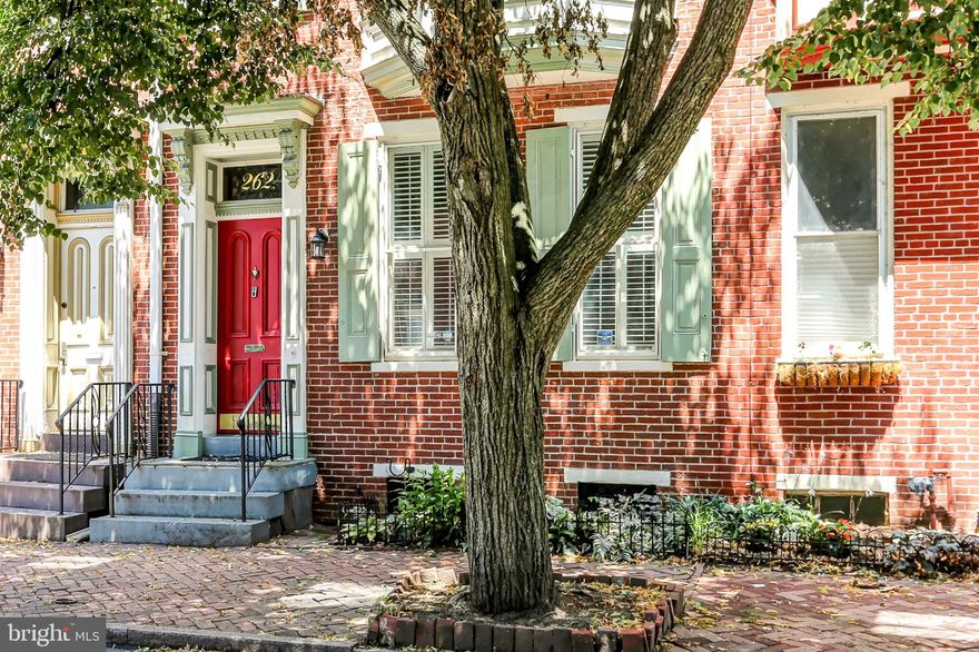 Character and charm blend seamlessly with modern upgrades at 262 Herr Street, ideally located in the heart of Historic Midtown Harrisburg.  A striking double-door entryway welcomes you into a spacious first floor featuring soaring ceilings, gleaming wood floors, and abundant natural light.  The generous Living Room showcases a gas fireplace with elegant marble surround and mantle and offers flexible living space that flows into the formal Dining Room—perfect for entertaining.  Convenient Half Bath too! The well-appointed Kitchen features an island, handsome backsplash, gas oven/range, built-in microwave, dishwasher, and refrigerator.  Glass doors open to a fully fenced courtyard with lush plantings—including ferns, oakleaf hydrangea, shadbush and many native plants.  The second floor hosts a spacious Primary Suite with en-suite Full Bath featuring a double sink vanity, bidet, and a versatile bonus room—a wonderful option for a home office or dressing room.  The second bedroom, currently used as a Den, offers newer carpeting and balcony access for quiet enjoyment.  Upstairs, the third floor includes an additional bedroom and a beautifully updated full bathroom with wood floors, oversized vanity, and a walk-in shower.  A few of the recent updates include an efficient natural gas furnace (2019), tankless water heater, and a new second-floor rubber roof (2020). Enjoy unbeatable walkability to Midtown’s best attractions—Broad Street Market, Millworks, Midtown Scholar, Riverfront Park, and more—all while being outside the 100-year flood plain.  Don't miss your chance to experience this beautiful home and vibrant community—schedule your showing today!