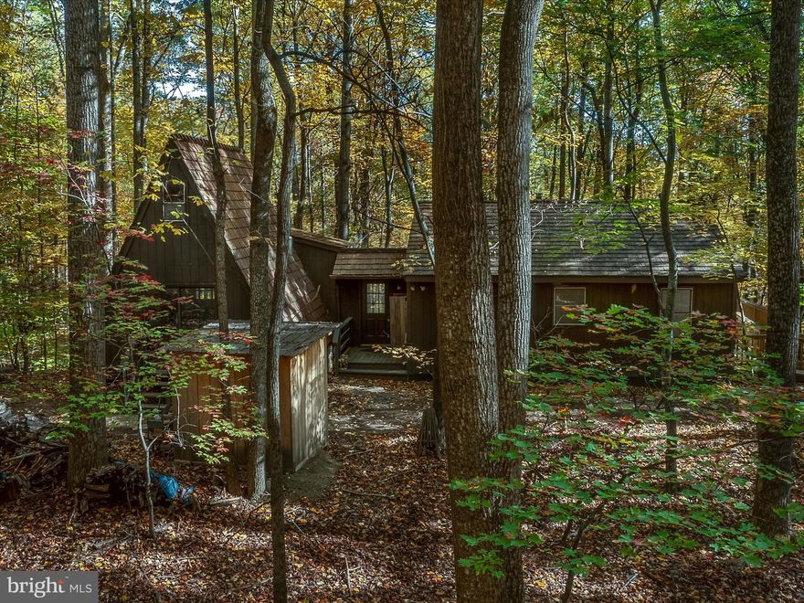 Very Unique Rancher with attached A-Frame - 1232 square feet of living space has be newly remodeled featuring:  3 Bedrooms, 1 Bath, Kitchen, breezeway to attached A-Frame with loft and woodstove to warm up to and loft if you need additional space.  Relax on the deck over looking the beautiful hardwood trees.   Very private location!   Situated on 2 lots totaling 10.72 acres centrally located 6 miles to Cacapon State Park that provides a host of activities that include fishing, swimming, hiking,  horseback riding, restaurants, new lodge and restaurant and a 19 hole golf course. Property is even closer to the newly reopened Coolfont Resort and only@ 6 miles to the downtown Berkeley Springs a very popular destination due to its charming shops, art galleries, restaurants, and spas.  S/D roads  are state maintained.