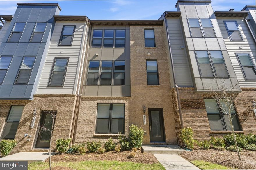 Don't miss this one.  Back on the market, no fault of seller.  Take a look and see this meticulous unit.  Welcome to this stunning brick front 3-bedroom, 2 full and 2 half bath townhome built by Stanley Martin, less than 4 years young and meticulously upgraded throughout. Featuring 10-foot ceilings and Chesapeake All-American laminate flooring in Century Oak on all three levels, this home offers a modern, cohesive feel. Abundant natural light pours in through oversized 7-foot windows, all fitted with cordless top-down/bottom-up honeycomb shades.

The entry level welcomes you with a spacious recreation room, convenient half bath, and access to the 2-car garage complete with an epoxy flake floor—both durable and stylish, and perfect for a home gym or additional workspace.

The main living level is designed for both everyday living and entertaining, featuring recessed lighting and an open layout filled with natural light. The gourmet kitchen is the centerpiece, showcasing white cabinetry, quartz countertops, stainless steel appliances, a flat surface electric cooktop, double oven, pantry, and a built-in work nook. The oversized 12-foot island comfortably seats four and includes a sink, making it ideal for gathering and conversation. The living room features a built-in electric fireplace and access to the deck, while the dining area provides the perfect setting for entertaining. A powder room completes this level.

Upstairs, you’ll find three bedrooms, including a spacious primary suite with recessed lighting and two walk-in closets. The luxurious primary bath offers double vanities, a private water closet, and an oversized shower. A full hall bath and full-size washer and dryer with additional shelving add convenience.

Location truly sets this home apart—just minutes to the Innovation Center Metro, Dulles Airport, shopping, dining, grocery stores, and Dulles South Recreation & Community Center.