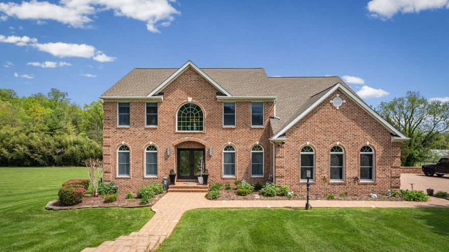 Welcome to this truly stunning brick accented colonial, perfectly situated on a premium, tree lined 1.24 acre lot in the prestigious Longfield Estates community. Thoughtfully updated throughout and meticulously maintained, this home showcases exceptional craftsmanship and attention to detail at every turn, highlighted by brick paver walkways, driveway, and an expansive pool deck, all enhanced with custom built in lighting.

Step through the elegant double entry doors into a breathtaking two story foyer with ceramic tile flooring and decorative inlay. The main level unfolds with sophistication, offering a formal dining room, formal living room, and office, all featuring ceramic tile flooring and detailed crown molding. The dining room, living room, and family room are further enhanced by beautiful Palladian windows, filling the home with natural light.

From the office, double doors lead to the impressive two story family room, featuring a dramatic floor to ceiling brick hearth fireplace, carpet flooring, a wall of windows overlooking the private rear yard oasis, and French doors providing access to the brick paver deck.

The gourmet eat in kitchen is designed to impress, showcasing custom porcelain tile flooring, a 5x5 breakfast bar island, granite countertops, tile backsplash, premium appliances, recessed lighting, table space, a butler’s pantry, and a coffee bar complete with beverage cooler. A slider offers seamless access to the rear brick paver deck, creating the perfect flow for entertaining. A full laundry room and powder room complete the main level.

Upstairs, the expansive primary suite features cathedral ceilings, a ceiling fan, a walk in closet, and a luxurious fully updated en suite bathroom with vaulted ceilings, dual granite vanities, glass tile backsplash, and an oversized walk in shower with frosted glass door, along with a dedicated dressing area. Three additional generously sized bedrooms complete the upper level, including a hall Jack and Jill bathroom shared by the third and fourth bedrooms.

The lower level continues to impress with 18x18 porcelain tile flooring throughout the expansive recreation space, highlighted by custom illuminated niches and recessed lighting. This level also features a versatile flex room with French door access to the rear yard, a game room with an eight seat granite wet bar, a full bathroom, and a dedicated fitness room, along with abundant storage throughout.

The attached two car side loading garage offers a custom tile floor and a workshop area.

The exterior is truly the crown jewel of this home. Enjoy a 12x25 brick paver deck with steps leading down to an extraordinary outdoor retreat, with a dedicated storage area located beneath the deck. The 24x42 heated saltwater in ground pool features an automatic safety cover and is surrounded by an expansive brick paver pool deck, complete with a built in bar, all set against the backdrop of the premium, tree lined rear yard, creating the ultimate private setting for entertaining and relaxation.

This exceptional property offers luxury, craftsmanship, prime location, and thoughtful design at every turn. A rare opportunity you will not want to miss.