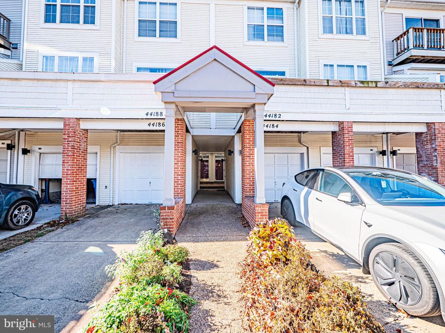 Tired of the cookie-cutter townhomes? Take a look at the unique California-style 2-level townhome (1466 SQ FT) featuring 3 bedrooms and 2.5 bathrooms in sought-after Ashburn Village. Nine-foot ceilings with an abundance of natural light and openness between the living/dining room and kitchen create a bright, open layout. The sunny kitchen attaches to a den with gas fireplace, ceramic floor and skylights make for a perfect place to host small parties or enjoy a cup of coffee view of the mature pine trees in the back. Sliding glass doors allow access to the brick porch in the back with a private small yard. The upper level includes large windows for two bedrooms with another room used for either another BR or office. Master bath has Jacuzzi jet bath and infrared heat lamp as well as a large closet. The two other rooms can be used for bedrooms or office space with another full bath. A detached garage and driveway are mere feet away from the front door. Updates include Water Heater (2024), Gutters (2024), Roof (2022), Stove (2022), Dishwasher (2022), A/C (2021), and Refrigerator (2020) with a marble countertop in the kitchen (2022). Many commuting options with the recent Ashburn Metro Station with free shuttle provided to and from this home location. Loudoun County Transit Commuter bus service is within 7 miles and reaches government offices and other locations in Washington DC. Easy access to Route 7, Dulles Toll Road and Dulles International Airport. Minutes from premier shopping, dining and entertainment options. Directly across the street is the Ashburn Village Sports Pavilion featuring 32,000 square feet of fitness and recreation to include indoor/outdoor pools, saunas, full gym, tennis courts, fitness studios, and even paddleboat/canoe rentals in Pavilion Lake. The lake features 1.5 miles of  paved trail filled with beautiful flowers and vegetation, fountains and vast wildlife including turtles, many fish species, frogs and bird species making it great for all ages to enjoy. Several tennis court locations with converted pickleball courts as well in three locations within Ashburn Village. Located half a mile from the W&OD Trail for biking/hiking and near many grocery store options.