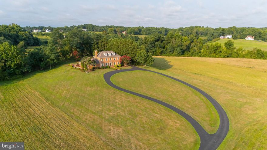 Welcome to The Estate on Carpenters Beach! 

This grand custom-built all-brick colonial home is perched atop a hill, offering breathtaking views of the Chesapeake Bay and private community beach access. The main level includes a bedroom that could be expanded into a primary suite. An elegant, extended circular driveway welcomes you to the residence. Designed to maximize the stunning water views, the sun-filled great room features Pella windows on all sides, a heated tile floor, a gas fireplace, and a Bose indoor/outdoor sound system.

The expansive chef's kitchen is equipped with Monogram stainless steel appliances, including a gas cooktop, double convection oven, and microwave/convection oven. It also includes a large island with beautiful granite countertops, abundant high-quality Wood-Mode cabinetry, three sinks, and a gas fireplace. The main level also features a stately dining room, a sizable living room, an office, a foyer with marble floors, and a laundry room. Gleaming oak hardwood floors and solid wood interior doors run throughout the home. With the owned solar panels, electric costs remain low.

Enjoy spectacular water views from the custom-designed outdoor terrace, featuring brick pavers, decorative slate edging, and artistic patterns. The peaceful outdoor living area is perfect for entertaining, dining, grilling, and steaming blue crabs. The private backyard provides a tranquil setting for sunrises and moonrises. The natural surroundings offer stunning night skies, meteor showers, full moons, and abundant wildlife, including bald eagles, ospreys, deer, and turkeys. This home is ideal for relaxing, entertaining, and enjoying a year-round vacation. It offers plenty of storage inside and out, with a large shed and an unfinished basement, which includes a rough-in for a bathroom.

Take advantage of easy access to the Chesapeake Bay and all the joys of "Bay Life." You'll enjoy the peacefulness and privacy of this location while still being conveniently close to shopping, the Park and Ride bus lot, urgent care, and a short commute to the Washington Metropolitan area.