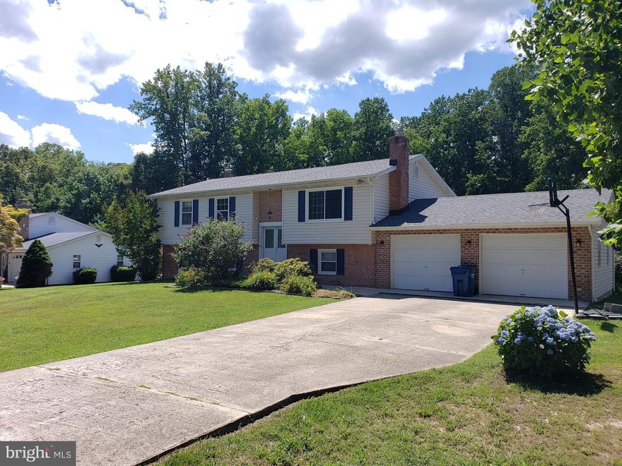 More photos coming soon.  Perfect for a growing family.  Located in the St Mary's school district but close enough for commuters traveling to DC or Pax River.  Updated kitchen with granite countertops and island open to family living space  great for every day living and entertaining guests.  Once you step out onto the expansive, full length deck and get a view of the fence back yard with above ground pool surrounded by a large deck, you will be sold!  Plenty of space to enjoy the outdoors year-round!  Summer days by the pool and spring and fall evenings around the fire pit.  The lower level with new carpet is also open and features a wet bar with kegerator, a wood stove insert in the brick fireplace, laundry room, storage space, a half bath and one bedroom.  Store all your stuff in the massive shed or in the two car attached garage.  Nearby restaurants and shops have everything you need in close proximity.