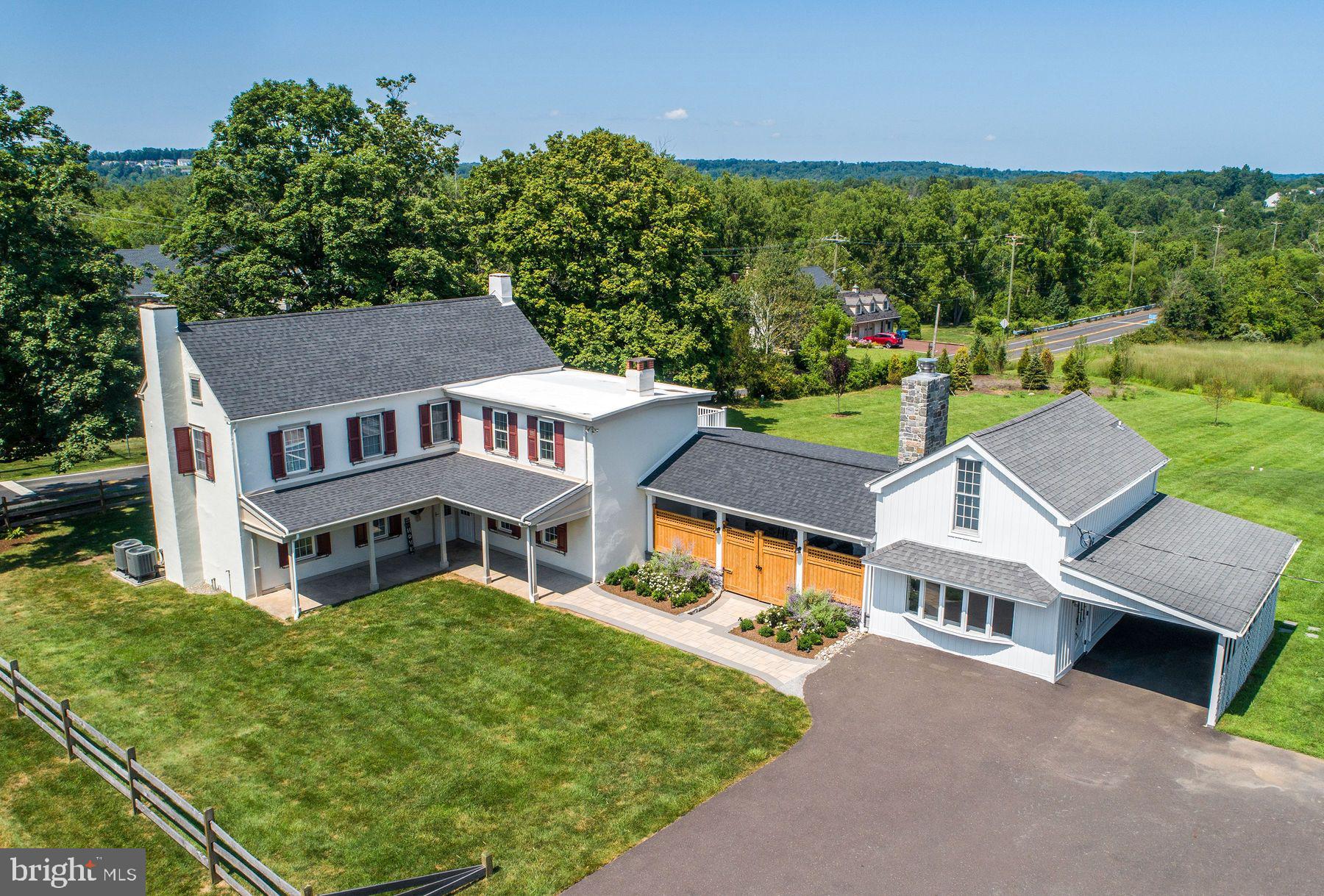 This stunning plaster over stone farmhouse seamlessly blends historic charm with thoughtful modern updates. Set on a picturesque parcel, the home features rich hardwood floors throughout, timeless character, and thoughtfully designed living spaces that honor its heritage while embracing today’s lifestyle. The heart of the home is a fully updated gourmet kitchen, thoughtfully designed for both everyday living and entertaining. Featuring high-end appliances, custom cabinetry, and ample workspace, it’s a chef’s dream come true. Abundant natural light, flexible living areas, including a separate space ideal for a home office, studio, or private gym, make this the perfect country retreat. Updated mechanical systems provide peace of mind, combining classic architecture with contemporary comfort. flexible living areas, including a separate space ideal for a home office, studio, or private gym. Outside, the property continues to impress. Enjoy an amazing outdoor kitchen and living area featuring a built-in fireplace—ideal for hosting gatherings or cozy evenings at home. A re-sided barn offers flexible space for storage, hobbies, or potential expansion, while a large pole barn/garage is a standout feature for the auto enthusiast—complete with a vehicle lift and room for multiple cars or workshop needs. Whether you're drawn to the historic allure, the modern amenities, or the top-tier garage setup, this farmhouse offers a rare opportunity to enjoy the best of both worlds in a truly special setting.