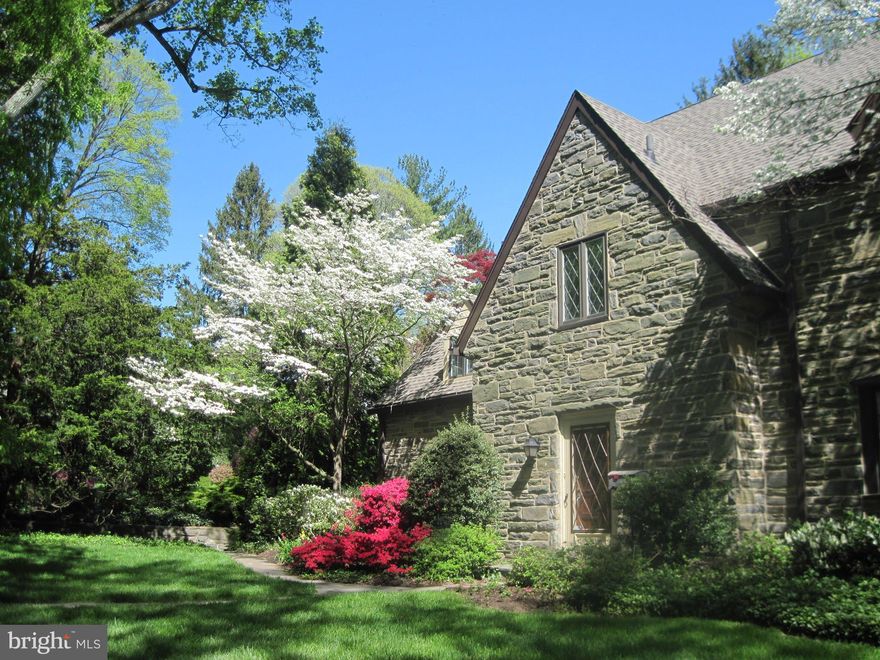 On highly sought after Moreno Rd sits a beautiful stone colonial with a separately deeded .65 acre lot (the lot is listed in the MLS for an additional $499,000) surrounded by a perimeter of mature trees and gorgeous landscaping. Moreno Rd is a quiet tree lined street tucked away in privacy yet in a great walkable location close to the center of Narberth, the train, shopping, restaurants and more. Approach the home down a beautiful slate walkway and enter the gracious foyer. The home has a Spacious and open floor plan with a Gourmet Eat-In Kitchen, Peninsula countertop seating, Jenn-Air appliances, triple sink and solid wood cabinetry. The kitchen is open to a breakfast room with wall of windows and extra pantry storage with easy access to the 3 car garage, blue stone patio and fenced in yard. Kitchen and breakfast are open to the Great Room with coffered ceilings, (gas heatilator) fireplace and beautiful hardwood floors which continue throughout the home. The Great Room has a wall of windows and sliding glass doors opening to a blue stone screened in porch (approx 400 sqft) overlooking the verdant separately deeded side yard and allows for gracious entertaining and sunlight to pour into these wonderful living spaces. The great room is open to the formal dining room with a pass-through to the kitchen (containing an infrared warmer enabling food to be kept warm while entertaining) and has french doors opening to the screened in porch. The dining room opens to the formal living room with fireplace and bay window. Continue through the first floor and you will find a powder room for guests, and a wood paneled library/study. A cozy first floor en suite bedroom and bath with walk in shower complete this level. Venture upstairs and be delighted to find an additional 4 bedrooms and 4 full baths with hardwood floors and newer windows throughout the home. The Master Bedroom is spacious with his and her closets, and a recently updated bath with walk-in shower. The Additional 3 Bedrooms all have their own bathrooms and plenty of storage including huge linen closet. Walk up the stairs to the third floor attic which is a large unfinished full ceiling height space with windows perfect if you wish to add additional bonus space or another Master Suite (plumbed for easy addition of a bath).The basement offers an additional playroom space with dry bar and spacious laundry room and separate storage or workshop area. Dog lovers will value the fenced dog pen that is accessed directly from the family room door leading to a 3-car detached garage. Newer windows throughout, GAF Timberline Lifetime Warranty Roof (2011) and James Hardie Fiber Cement Siding (2011). Home has 400 amp. electrical service and 2-zoned heating/air conditioning system. Award Winning Lower Merion School District this is a Choice Area for High Schools. Adjacent to the home is a separately deeded 0.67-acre landscaped corner lot. All offers will be reviewed July 3rd.