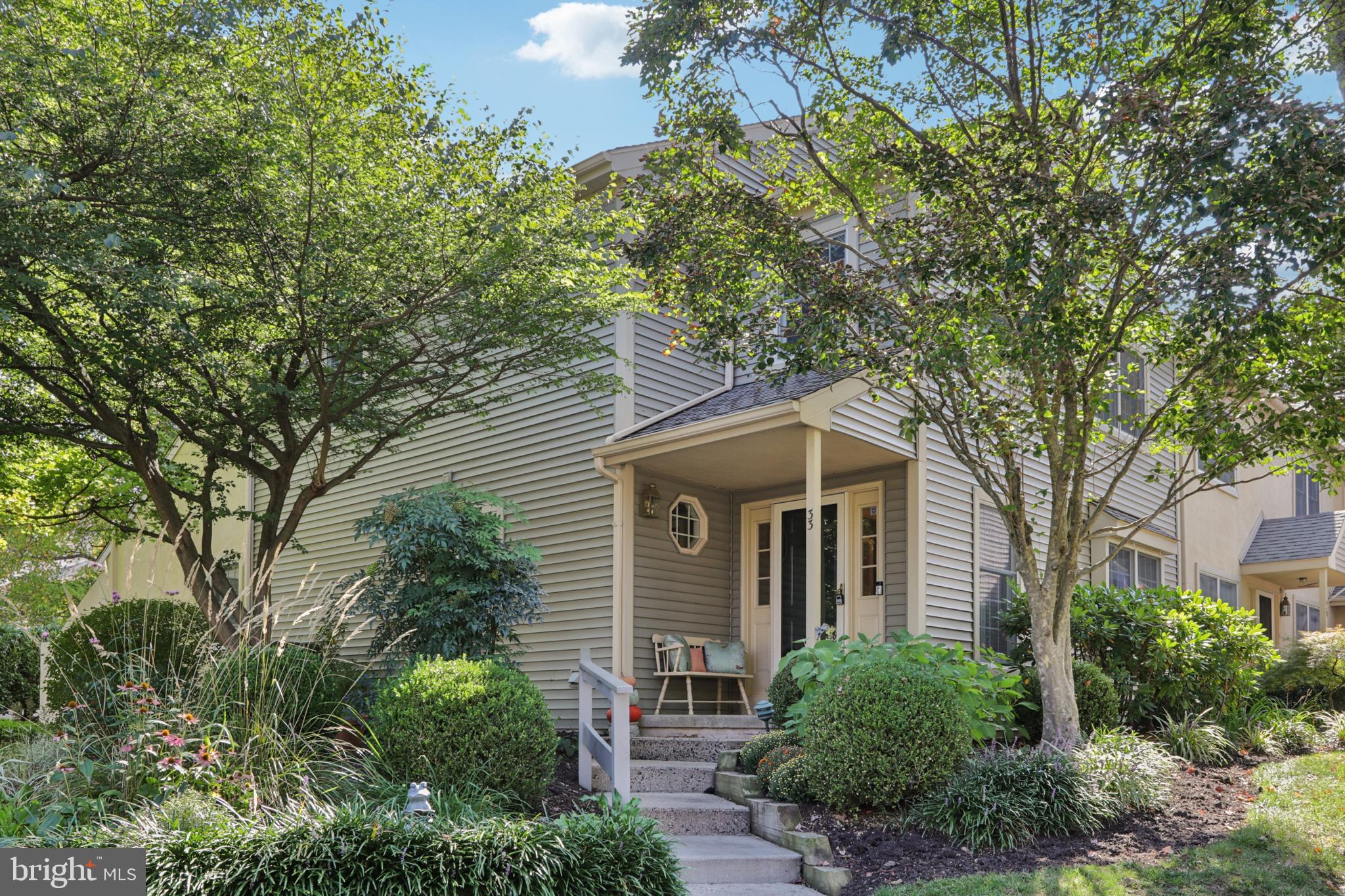 Welcome to 33 Wingstone Lane, a charming end unit townhome in the well maintained Devonshire neighborhood. This 38 home community is set on 13 acres of beautifully landscaped grounds, with many amenities. Offering an open, bright layout , this residence provides an easy life style and low-maintenance living.
A private walkway leads to a covered front porch and inviting foyer. Hardwood floors flow throughout most of the main level, including the formal dining room and spacious living room with cathedral ceiling and upgraded wood burning fireplace. Two newer sliding doors connect the living area to a large deck with partial awning -- perfect for outdoor relaxation or entertaining,
To the right of the foyer is the updated eat-in kitchen, featuring granite countertops, stainless steel appliances and plantation shutters. A powder room and convenient laundry (all with hardwood) complete this hallway.
The first floor primary suite includes a dressing area with two closets and a renovated en-suite bath with a large tiled walk-in shower, and direct access to both the deck and laundry room.
Upstairs, a sunlit loft with skylights overlooks the living room and provides flexible space for an office, sitting area or den. Two additional bedrooms, a hall bath, and two oversized walk-in closets complete the second floor.
The partially finished basement offers a drop ceiling, built in desk with cabinets, an open sitting or exercise area plus a spacious work/storage section with shelving and a workbench.
This lovely home provides privacy and convenience, located close to the Devon SEPTA station, post office, Main Line dining and shopping and major routes.