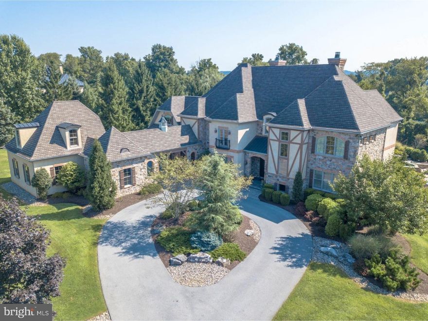 SALE PENDING....Custom details and elegant appointments throughout this dramatic home are testimony to the attention to detail in design and construction. Built in 2008, vaulted ceilings, a captivating entrance foyer, dark walnut floors, handsome built-ins, and custom cabinetry are examples of items that set this home apart from the ordinary. Designed for sophisticated entertaining as well as intimate family living, the floor plan is an opulent play on interconnecting spaces, walls of windows, detailed moldings and wood, stone, and brick accents.  Serving as the hub of the first floor, the gracious living room is anchored by a dramatic fireplace with a French antique limestone mantel and opens to the cozy study and a tiered terrace overlooking a fabulous pool and spa. The kitchen is a masterpiece, boasting a Wolf range, top-of-the-line appliances, granite, stone, and brick detailing and an open design for the most serious of cooks, with a butler's pantry leading to a beautiful dining room.  High ceilings, an elegant office, and vaulted family room with stone fireplace complete the first floor. On the second floor is a sumptuous master suite with fireplace, vanity room and elegant bath. Handsomely appointed, there are 3 additional en suite bedrooms and a guest suite.  A future elevator, advanced lighting, music, intercom and security systems, and 4 garage bays with bonus storage room are just a few of the luxurious upgrades. But the piece-de-resistance is the extravagantly-appointed and newly finished walk-out lower level with home theater/golf simulator, 2nd kitchen, game room, bonus room and full bath.  Just minutes to I-78, Saucon Valley Country Club, and local hospitals.