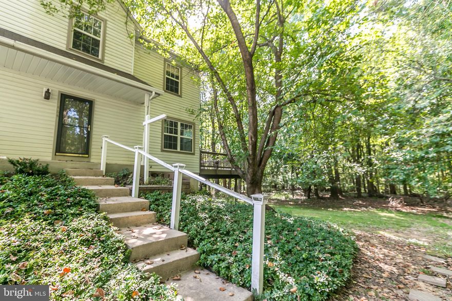 LOCATION, LOCATION, LOCATION.  Close proximity to loads of restaurants, shops and major routes but tucked away at the end of the community.  This end of group town home backs to the woods so you feel like you are in a private enclave enjoying the nature that surrounds! Features include, updated kitchen with granite countertops and stainless steel appliances, fully finished lower level family room with full bath, large deck overlooking the woods off of the dining room, spacious living room, masterbedroom has ensuite bathroom, two full baths on upper level, replaced windows, newer AC and 2 assigned parking spaces.  Priced to sell, cheaper than rent! Move right in and enjoy the Autumn with this beautiful view!