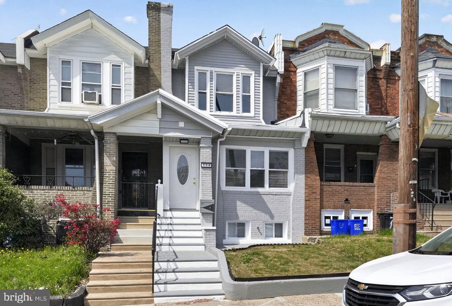 Welcome to 714 Marlyn Road, a 3-bedroom, 2.5-bath rowhome in Philadelphia. As you approach, a short set of steps leads to the front entry. Inside, a long foyer runs alongside the open main living space. The dining area features hardwood floors and chair rail, flowing into the living room with hardwood flooring, chair rail, and an electric fireplace with a TV niche above. A convenient powder room is located just off the living area. The kitchen includes hardwood floors, quartz countertops, and stainless steel appliances. A laundry closet with a stacked washer and dryer completes the main level. Upstairs, the primary bedroom features hardwood floors and an electric fireplace. The full hall bathroom offers tile flooring, large stone-tiled walls, and a tub and shower combination. Two additional bedrooms, both with hardwood floors, provide flexible space for family, guests, or a home office. The finished basement adds additional living space with a family room featuring luxury vinyl plank flooring and an electric fireplace. A bonus room offers options for a playroom, gym, or storage. This level also includes a second full bathroom with tile flooring, stone-tiled walls, and a tub and shower combination, along with a separate door to the fenced concrete patio, which can also be reached from the kitchen. Conveniently located near local shopping, grocery stores, restaurants, Lancaster Avenue, and Route 1, this home offers both comfort and accessibility. Don’t miss the opportunity to make 714 Marlyn Road your new home.