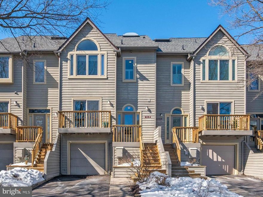 This marina-front townhome offers beautiful views of the Chesapeake Harbour marina and the Chesapeake Bay, with an open, light-filled floor plan that embraces the waterfront setting. Sunlight fills the main level, where refinished hardwood floors and open living and dining spaces create a natural gathering place for both relaxed everyday living and entertaining. The kitchen has been enhanced with a center island with a Quartz countertop that adds both function and casual seating, along with a new refrigerator. Removal of the knee wall between the dining and living rooms allows the space to feel more connected and open. Hardwood flooring continues up the stairs and throughout the upper hallway and primary suite, while custom glass stair panels add a clean, modern architectural element that enhances the home’s sense of openness. Brand new carpet on the stairs to the lower level adds comfort and warmth. The primary suite offers a calm and comfortable retreat, complemented by a shiplap accent wall and thoughtful finishes. The loft level is currently designed as a custom walk-in closet and dressing room with built-ins, providing exceptional storage while easily adaptable as a bedroom, home office, or private space. Life in Chesapeake Harbour offers a truly special waterfront lifestyle, with 24-hour gated security, two outdoor pools, tennis courts, a sandy beach, scenic walking and jogging paths, an on-site marina, and waterfront dining. Whether enjoying quiet mornings by the water or the convenience of being just minutes from downtown Annapolis, this home offers the ease and beauty of marina-front living in one of Annapolis’ most desirable gated communities.