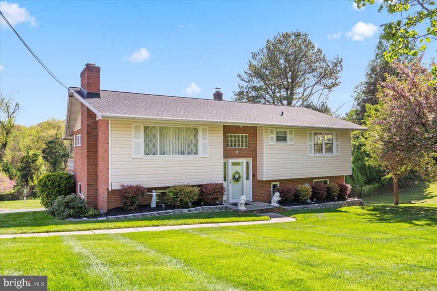 COZY 3 Bedroom 1.5 Bath BRICK Split Level Detached Home on just over an  ACRE lot * Features Include:  SPACIOUS sun filled living room with WOOD burning fireplace * Separate dining room * EAT in kitchen * THREE bedrooms and one FULL Bath complete the MAIN level * COVERED main level deck * The LOWER level has a LARGE family room, HALF bath, laundry and sliders to a covered patio * BEAUTIFUL gardens and HUGE well manicured yard with plenty of trees that offer privacy * NEW ARCHITECTURAL  shingled roof * ATTACHED rear entry one car garage * DETACHED carport * IMMENSE driveway with room for 8+ cars * This IMMACULATE home is close to shops and restaurants and cannot be missed!