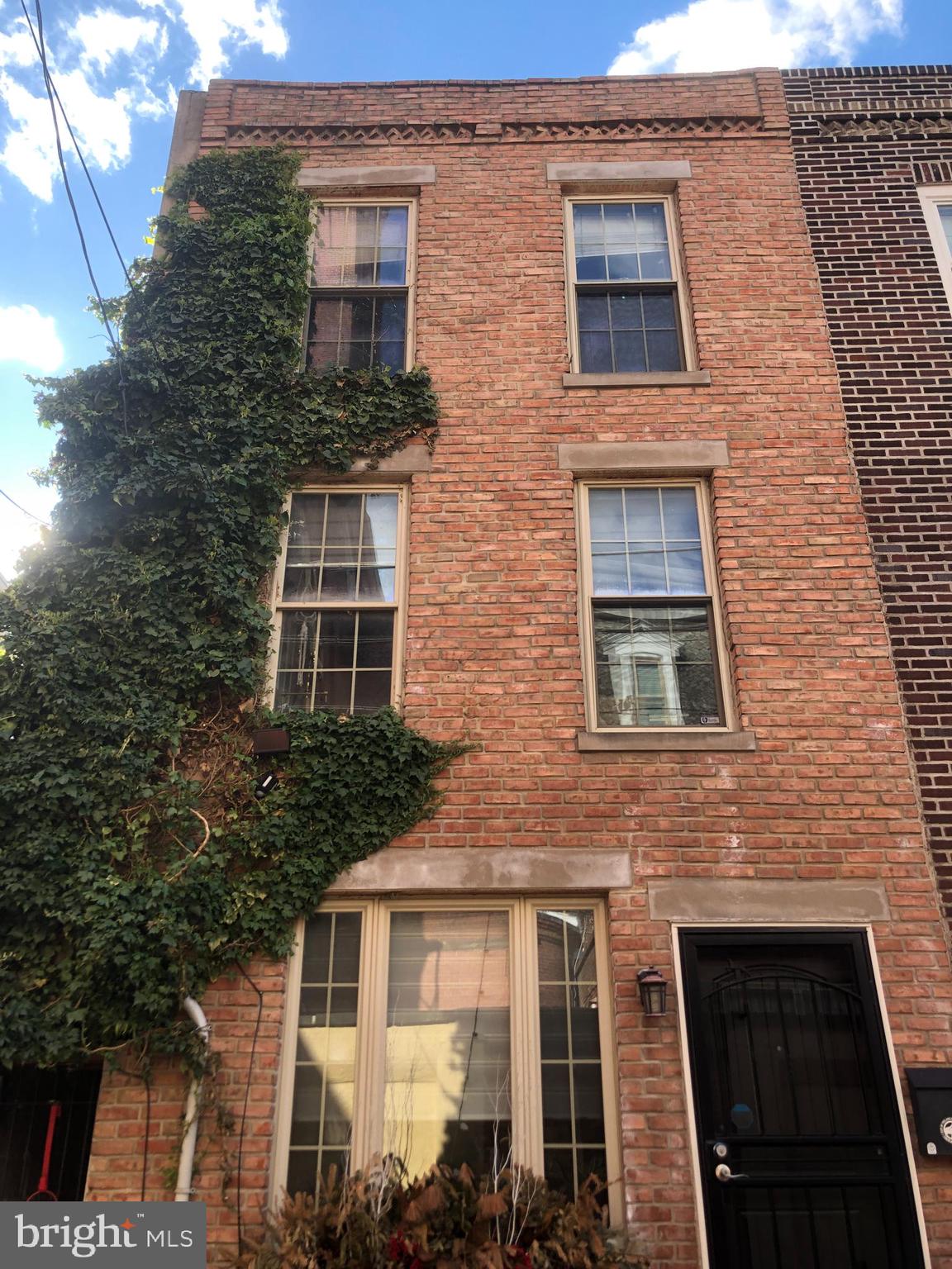 Nestled in a quiet and quaint alleyway in the heart of the desirable Bella Vista area, you’ll fall in love with this beautiful three-story townhouse. Mixed with both historic architectural charm and modern upgrades and aesthetics. The first floor features an open kitchen, living room, and back door exit to a private alleyway. On the second floor, you’ll find the first two bedrooms, where one is currently converted into your dream walk-in closet, which can also be used as a home office or nursery. The entire third floor welcomes you to the gorgeous open-concept master bed and bath. As you journey through each unique room, notice the details of every glistening chandelier and the original exposed brick walls.Â
This home is one block from the Italian Market filled with historic restaurants, an outdoor fruit and vegetable market, small businesses, and coffee shops. Whole Foods and Acme are a short walk away. There is also a recreation center and playground one block away. Here you will feel a true neighborhood vibe while also getting to experience all the city has to offer. For those who love character, beauty, and comfort, come make this place your home and schedule your showing today. You don’t want to miss this unique home in this prime location.