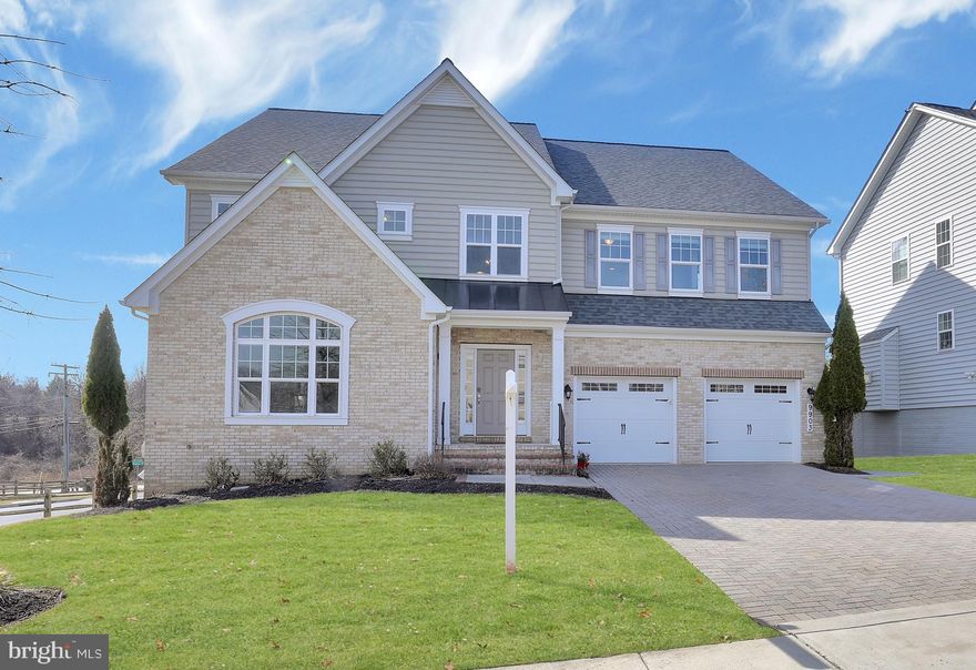 Welcome to this rarely available and exquisitely designed 2016 Beazer-built Federalsburg model, a true masterpiece of craftsmanship nestled in the prestigious Wincopia Farms community. This stunning brick-front estate offers six bedrooms and five full bathrooms, including a highly sought-after main-level bedroom with a private en-suite bath. Designed with luxury and functionality in mind, this home showcases an open-concept layout with a fresh palette with thoughtfully coated paint and carpet, soaring ceilings, luxury vinyl plank & luxury vinyl tile flooring, and sun-drenched interiors, creating a sophisticated yet inviting ambiance. The gourmet chef’s kitchen is a culinary delight, featuring 42” designer gray cabinetry, quartz countertops, high-end stainless steel appliances, an oversized quartz island with brand-new pendant lighting, a walk-in pantry, a quartz butler’s pantry, and an upgraded gas cooktop with an exterior vented exhaust microwave. A custom backsplash, breakfast bar, and a sunlit morning room adorned with elegant chandeliers complete this spectacular space. Flowing seamlessly from the kitchen, the magnificent two-story great room boasts a floor-to-ceiling stoned gas fireplace, serving as the perfect gathering place for both intimate evenings and grand entertaining. The expansive primary suite is a private retreat, offering a spa-inspired en-suite bath with a soaking tub, frameless glass shower, and dual vanities, along with a spacious walk-in closet and custom window treatments. Three additional generously sized bedrooms, each with walk-in closets, and two en-suite bathrooms, a convenient walk-in laundry room with a brand-new sink and cabinetry adds to the home’s thoughtful design and complete the upper level living quarters. The fully finished walk-out lower level presents a versatile living space, featuring a full bedroom and bath, a private exercise room with built-in mirrors and rubber mat flooring, and additional unfinished space ideal for storage or customization. Designed for exceptional outdoor living, this home boasts a Granite City Paver patio with luxurious Blue Stone built-in seating, a built-in fireplace, and a fully equipped outdoor kitchen, complete with a Kamado Joe Big Joe Grill III, EVO Affinity 30G Built-In Flattop Natural Gas Grill, and a Gozney Dome high-end outdoor pizza oven. The expansive deck, enhanced with outdoor lighting and a premium speaker system with a paver sidewalk to the front to the home, creates an entertainer’s paradise, perfect for hosting unforgettable gatherings. Situated on one of the largest lots in the community, this residence also features a spacious two-car garage, an expansive brick-paved driveway, and an underground irrigation system to maintain lush, vibrant landscaping year-round. Built with energy efficiency and smart technology, this home includes home network wiring, a 92% efficient gas heating system, a high-efficiency HVAC system, Nest programmable thermostat, Tyvek HomeWrap, insulated dual-pane windows with Low-E glass, R-19 exterior wall insulation, R-49 attic insulation, R-38 to R-50 cantilever insulation, air barrier and ductwork sealing, 2x6 exterior wall framing, an insulated steel garage door with a fully equipped garage with 2 electric car charging outlets, and 45-year architectural roof shingles installed in 2021. Residents can enjoy scenic walking trails, a gated playground, and a charming picnic area, perfect for creating lifelong memories. Conveniently located just minutes from premier shopping, dining, and major commuting routes, including Ft. Meade, Columbia, Baltimore, and Washington, D.C., with seamless access to I-95, US-29, MD-32, and MD-216, this home is also zoned for the top-ranked Howard County School District. A private tunnel connects directly to Murray Hill Middle and Gorman Elementary, making school commutes effortless. This meticulously maintained, move-in-ready estate is a rare opportunity in one of Howa