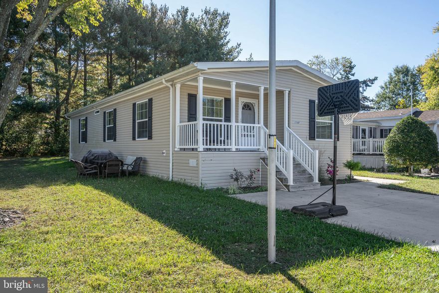 Welcome to this meticulous, light and bright 3-bedroom, 2-bathroom home located in the desirable Sweetbriar community of Lewes, Delaware—a charming waterfront neighborhood perfectly positioned for coastal living. Step inside to find an inviting open-concept layout designed for comfort and style. The kitchen is a chef’s delight, featuring stainless steel appliances, double sinks, a center island with counter seating, a built-in microwave, and elegant luxury vinyl plank flooring that flows seamlessly into the carpeted living and dining rooms. The primary bedroom suite offers a peaceful retreat with an ensuite bathroom complete with a step-in shower. Additional conveniences include a mudroom with washer/dryer hookups, a coat and shoe rack with bench, and a welcoming covered front porch—perfect for relaxing and enjoying the tranquil surroundings. Backing to trees for added privacy, this home offers a serene setting while being just minutes from downtown Lewes, Red Mill Pond, and miles of Delaware shoreline. Enjoy easy access to the bike trail, Rehoboth Beach outlets, shopping, dining, entertainment, and endless opportunities for boating, fishing, and outdoor recreation. Experience the perfect blend of coastal charm, modern comfort, and convenient location in this Sweetbriar gem!