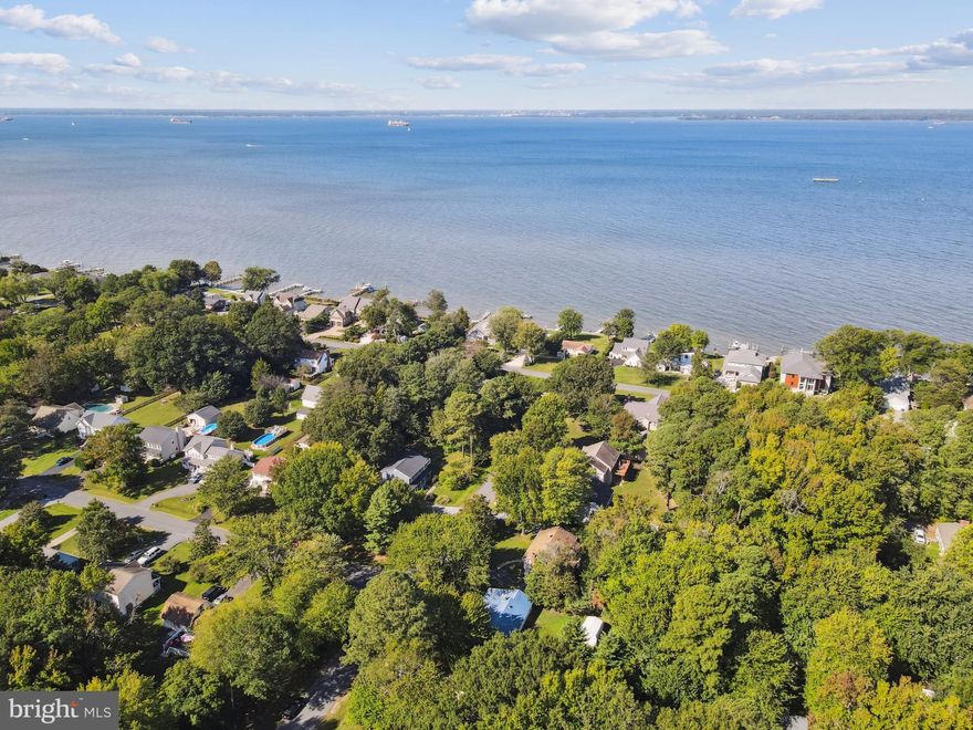 Welcome to your storybook cottage in Bay City, Stevensville—just steps from the shimmering waters of the Chesapeake. This isn’t just a house; it’s a lifestyle. Imagine morning coffee with water views, evening strolls by the pier, and sunsets that look like they belong on a postcard (or better yet, a Hallmark movie).

Community Perks You'll Love
Bay City is one of Kent Island’s most sought-after neighborhoods for a reason. Enjoy two waterfront parks—one with a brand-new playground within walking distance, the other offering a sandy beach, boat ramp, picnic pavilion, kayak racks, and a pier perfect for launching small craft or simply soaking in the views. Shopping, dining, and outdoor recreation are minutes away, and with Route 50/301 nearby, the Bay Bridge commute is a breeze.

 Inside Your Cottage Retreat
This 3-bedroom gem has been refreshed top-to-bottom with $50,000 in recent upgrades:
A dream kitchen with quartz counters, a farmhouse sink, custom cabinetry, and an oversized LG refrigerator.
A spa-inspired bath featuring ocean-blue tile, marble floors, and all-new fixtures.
Fresh flooring, paint, and a welcoming front porch.

Natural light fills the versatile floor plan, and select rooms even frame the water. Want more? The front porch could become extra living space, or picture a rear deck overlooking your spacious backyard.

The Outdoors: Room to Grow
On nearly a third of an acre, the lot features majestic 200-year-old trees at the front and ample open space at the back for a garage, garden, or private retreat. A long driveway accommodates multiple cars—and yes, even your RV. The home also features a durable metal roof and a fully finished attic. *Shed is not warranted nor guaranteed to be structurally solid.*

 Why Wait?
This Bay City cottage blends timeless charm with thoughtful updates, all in a water-privileged community where the sunsets will stop you in your tracks. Opportunities like this don’t linger—schedule your private showing today and start your Chesapeake chapter.