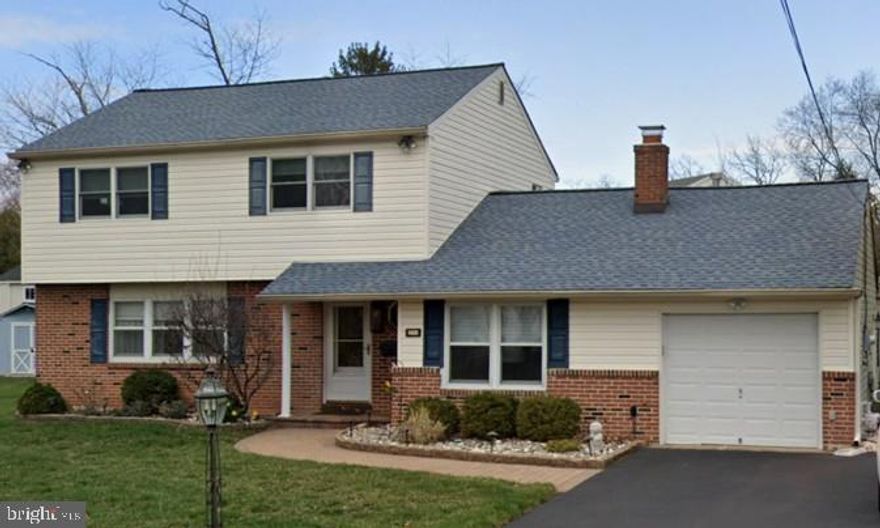 Exceptional pride of ownership defines this beautifully maintained 4-bedroom Colonial, ideally situated on a generous .36-acre lot in Warminster. Offering approximately 2,590 square feet of thoughtfully designed living space, this home seamlessly blends timeless character with modern updates.

A welcoming foyer opens to a sun-filled formal living room highlighted by a large picture window overlooking the manicured front yard. The adjacent dining room features sliding French doors that lead to the rear patio—creating an effortless indoor-outdoor flow ideal for entertaining.

The spacious eat-in kitchen overlooks the private backyard and is appointed with oak cabinetry, granite countertops, stainless steel appliances, tile backsplash, and ample workspace. Just off the kitchen, the inviting family room is anchored by a gas fireplace with elegant marble surround—perfect for cozy evenings. A substantial rear addition offers versatile living space ideal for a home office, playroom, or media room and showcases custom built-in bookcases.

A convenient first-floor laundry room and powder room complete the main level.

Upstairs, four generously sized bedrooms and two full baths provide comfortable accommodations. The fully finished basement expands the home’s living space, offering endless possibilities for recreation or relaxation. A large attic provides exceptional storage.

Additional highlights include a one-car garage, expansive backyard, and numerous updates throughout. A truly move-in-ready home that reflects meticulous care and lasting quality.