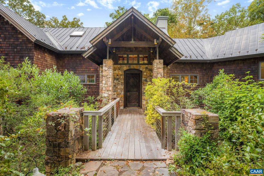 Discover this stunning architect-designed custom home, built in 1998, nestled on 21 elevated acres with views of the Rivanna Reservoir and the Blue Ridge Mountains. This exceptional property features exquisite details such as reclaimed oak and pine flooring, handcrafted heart pine cabinetry, and large glass windows that fill the space with natural light. Enjoy outdoor living on the expansive Brazilian Ipe hardwood decks or relax in the spacious screened porch. The kitchen boasts elegant soapstone countertops, while the living room showcases a dramatic 20-foot stone fireplace, perfect for cozy gatherings. With soaring ceilings and vast glass expanses, the home seamlessly blends indoor comfort with the beauty of its surroundings. Encompassed by lovely landscaping, this tranquil retreat is just three miles from Charlottesville. Amenities include a standing seam copper roof, abundant built-ins, and a geothermal HVAC system for energy efficiency. The property is primarily wooded and under conservation easement, ensuring low maintenance. Experience the magnificence of Tranquility Ridge?where natural beauty meets refined living!,Cherry Cabinets,Soapstone Counter,Wood Cabinets,Fireplace in Living Room