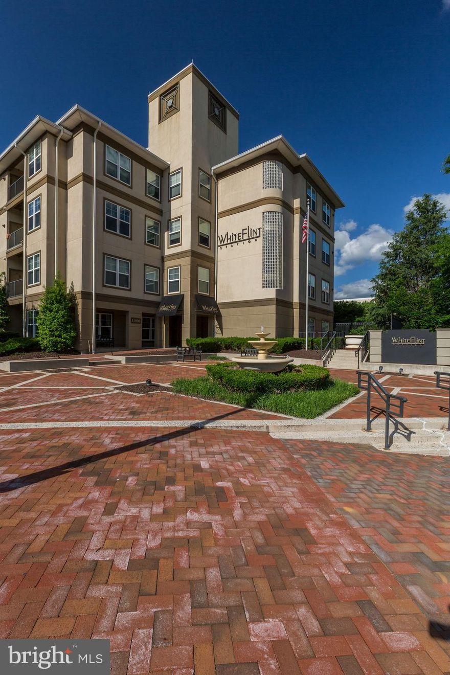 Beautiful condo in secure, elevator building w/pool, gym, & community center. Condo has hardwood floors, ss appliances, recently updated counters, balcony, & full size washer & dryer. Perfect location!  Adjacent to White Flint Metro, Pike and Rose (restaurants, Starbucks, movie theater, shopping), & minutes to Whole Foods! Garage parking. Must see!