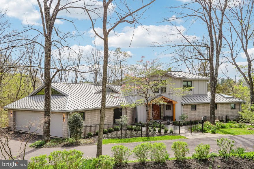 Architectural Masterpiece on 4.33 Wooded Acres in Newtown, PA
Designed by renowned New York architect Pamela Jenkins, this breathtaking 7,700 sq ft estate is a rare fusion of art, architecture, and nature. Set on 4.33 private acres in sought-after Upper Makefield Township, the home is a tribute to fine craftsmanship and thoughtful design. A perfect setting to display and share your art and collectibles with your family and friends.
Artistry & Architecture in Harmony:
Architectural Vision: The home’s bold, clean lines and expansive spaces are hallmarks of Jenkins’ work, elevated by museum-quality finishes and artisanal touches throughout.
Main Foyer Statement: A dramatic 30-foot ceiling makes a striking first impression, anchored by a handcrafted exotic wood front door that sets the tone for expansive gallery like space on the first floor..
Great Room Elegance: A spacious and light-filled great room with fireplace surround features sculptural clay work by the late Paula Colton Winokur, one of the leading ceramic artists in the U.S. from the 1970s until her passing, floor to ceiling windows and 20ft ceilings.
Kitchen as Art: The custom tile installation was crafted by acclaimed ceramic artist Bob Winokur, transforming the gourmet kitchen into a functional masterpiece.
Layout & Lifestyle:
Primary Suite Retreat: located on main level , the large owners suite features a private sitting area with gas fireplace with beautiful marble surround and built in book cases, and dual his and her bathrooms, offering spa-like privacy and luxury.
3 additional Bedrooms and 2 additional Bathrooms – including one bedroom currently utilized as a stylish home office.
Outdoor Oasis: A generous deck and screened-in porch overlook the tranquil, wooded property, with a stream running through the back of the property —ideal for quiet mornings or elegant entertaining.
Additional Features: 3-car garage, partially finished garden level walk out basement with state of the art home theater and gym,  living area, and abundant storage,  butlers pantry, 
Located just minutes from charming downtown Newtown and top-rated schools, this home offers convenience and privacy in one of Bucks County’s most prestigious neighborhoods.