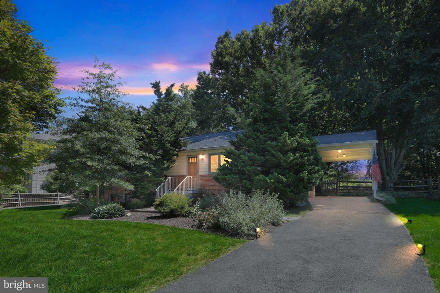 Nestled on a beautifully landscaped 28,689 sq. ft. lot, this classic brick rambler offers an exceptional blend of space, comfort, and charm—all just minutes from downtown Vienna’s shops, dining, parks, and top-rated schools.

The main level features three generous bedrooms and two full baths, with gleaming hardwood floors flowing seamlessly throughout. A thoughtfully designed rear addition enhances the home’s livability, creating a light-filled, open-concept space ideal for both everyday living and effortless entertaining. The inviting living room centers around a traditional wood-burning fireplace which has been converted for a gas insert or logs, while a separate family room offers additional space for relaxation and gatherings.

The walkout lower level expands the home’s versatility with a spacious finished recreation room anchored by a second wood-burning fireplace, a large den, and a full bath—perfect for guests, an office, or multi-generational living.

This home is fully equipped with natural gas, providing an easy opportunity for future gas conversions, and it is also wired to accommodate a natural gas generator—offering added peace of mind for buyers seeking backup power capabilities.

Step outside to your private backyard oasis, where mature trees and expansive green space offer endless potential—whether you envision lush gardens, outdoor entertaining areas, or future expansion possibilities.

With a one-car parking pad, solid construction, and a meticulously maintained interior, this home is move-in ready while also offering the flexibility to personalize or renovate over time. Rarely does a property combine this much land, location, and timeless character in such a sought-after Vienna setting.