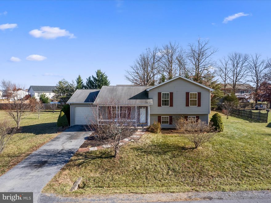 NEW PRICE!  This charming split-level home has been freshly painted and features new flooring throughout, ready for you to make it your own! As you enter, you'll find the open living room, kitchen, and dining areas on the main level, which also lead to the back deck, offering a scenic view of the large lot in this commuter-friendly community. Upstairs, you'll find three bedrooms and a full bathroom. Downstairs, there's a cozy family room, another full bath, laundry area, and an additional room that can serve as a bedroom or home office with its own exterior access. With easy access to Routes 51 and 11, as well as I-81, this home offers a convenient commute to work and the new stores coming to Inwood. Schedule your showing today!