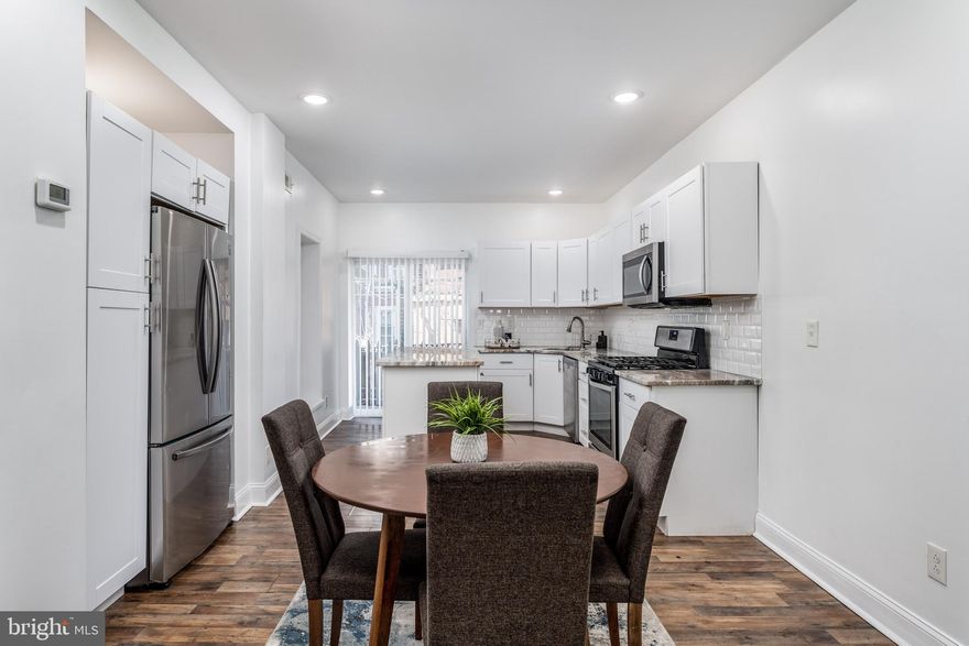 This recently renovated 3-bedroom, 1.5-bath Brewerytown townhome truly has it all. Step into a bright, spacious living area filled with natural light that flows seamlessly into the dining space, ideal for both everyday living and entertaining. The updated kitchen features stainless steel appliances, generous cabinetry, and a convenient island for additional cooking space and seating for a quick meal. The kitchen offers direct access to a private rear deck through sliding glass doors - perfect for outdoor dining or relaxing evenings. A convenient powder room completes the main level. Upstairs, you’ll find three well-sized bedrooms, each offering ample closet space and natural light, along with a full bathroom. The finished basement provides flexible additional living or entertaining space, plus extra storage, and includes a washer and dryer for added convenience. Ideally situated near Sedgley Woods and the Ridge Transportation Center, this home offers easy access to outdoor recreation, transit, and everything Brewerytown has to offer.