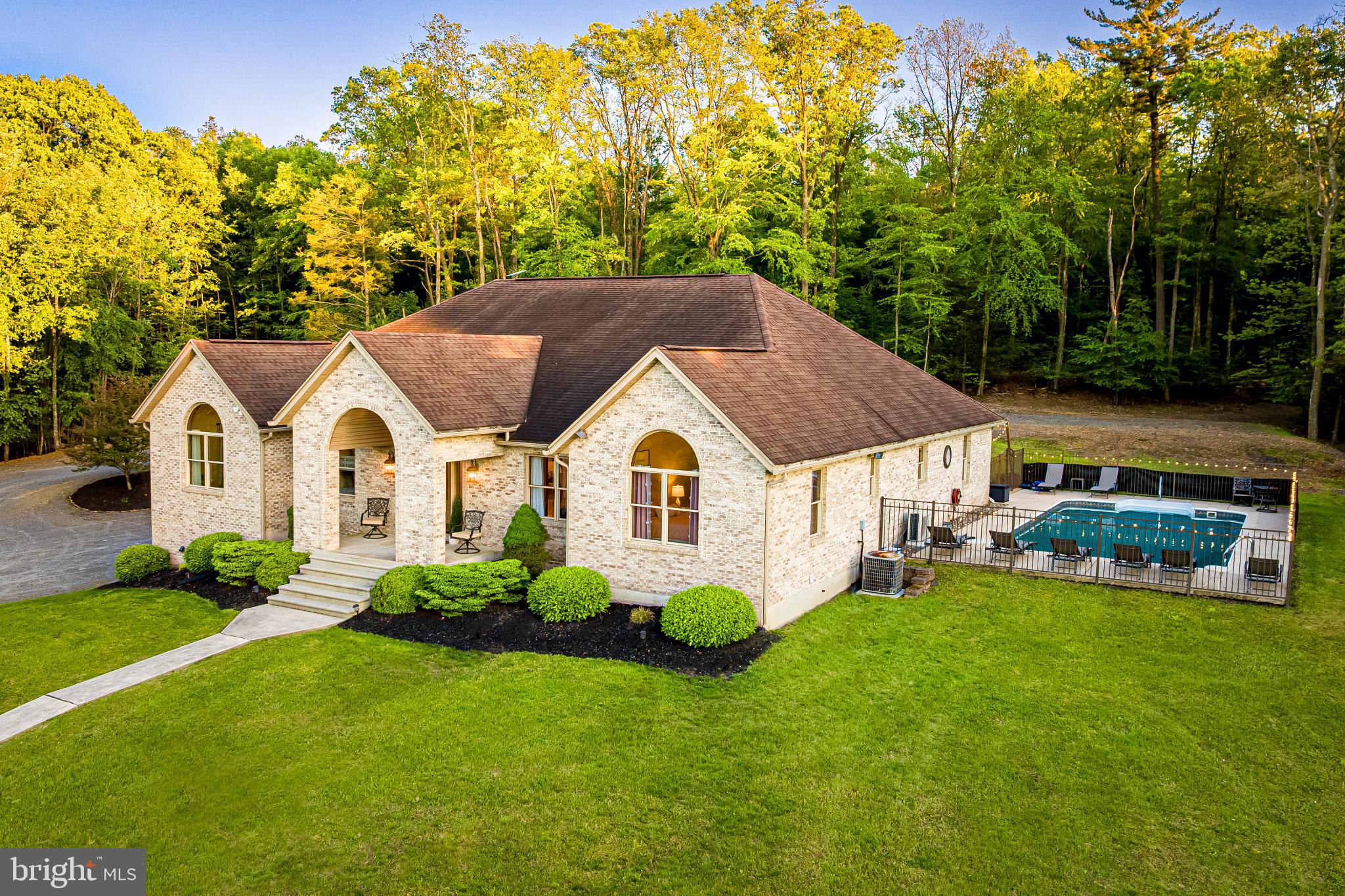 This stunning estate in the heart of the Blue Mountains offers luxury, privacy, and natural beauty. The property features a custom, all-brick manor house with 5 bedrooms and 4.5 baths on 46 acres of mostly wooded land, providing a tranquil, hilltop retreat with year-round views and abundant wildlife, including fantastic white-tail deer hunting.
The home boasts a marble entry foyer and custom tile work. The living room, office, and front bedroom showcase beautiful Brazilian cherry hardwood floors. The living and dining rooms open to a covered rear patio, ideal for outdoor entertaining. The chef’s kitchen features custom cabinets, a stunning backsplash, granite countertops, and a large island.
The master suite offers breathtaking views of the pristine pool and a luxurious bath with custom tile work and a Jacuzzi tub. The first floor includes three additional bedrooms, three full baths, a half bath, and an office. The finished lower level features a recreation room, additional kitchen, bedroom, and full bath—perfect for an in-law suite. An oversized, heated two-car garage and utility room complete the lower level.
Enjoy outdoor living with a recessed covered porch, heated pool, hot tub, outdoor grill, fire pit, picnic area and more.
The property it is STR (Airbnb) approved for 14 guests making it a great option for pleasure and investment all in one.
All furnishings throughout the house are for sale. Its new, quality furniture.