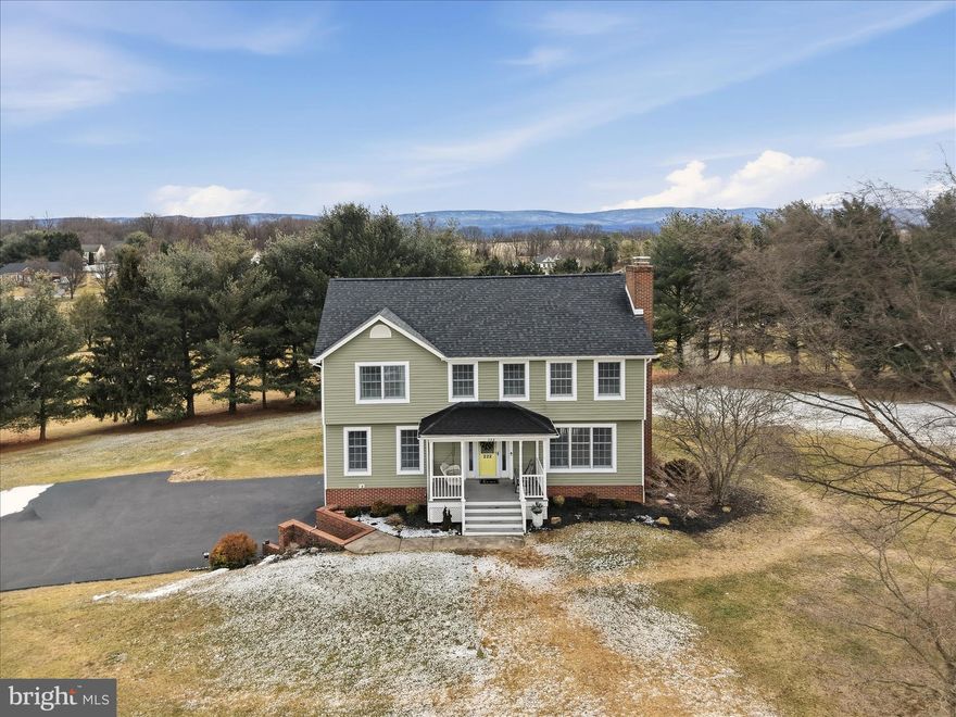 Beautifully maintained home on a corner lot of over one acre with stunning mountain views. A welcoming front porch with a porch swing sets the tone for relaxed living. Inside, you’ll find gleaming hardwood floors, fresh paint, new carpet, and thoughtfully remodeled kitchen and baths.

The light-filled kitchen features solid surface counters, under-cabinet lighting, and direct access to the spacious deck, perfect for enjoying the views. (Kitchen island conveys.) The adjoining family room offers a cozy gas fireplace, while the flexible layout provides both open gathering spaces and private retreats.

Upstairs includes three generously sized bedrooms. The primary suite features a fully renovated ensuite bath and two walk-in closets. Two additional bedrooms share an updated hall bath, and a dedicated laundry room completes the upper level.

The finished basement adds versatile living space with a wood-burning fireplace, ideal for a den, home office, gym, or playroom. An oversized two-car garage, storage shed with power, and abundant closet space provide excellent storage options.

Tucked within a quiet neighborhood with convenient access to Route 340, and just minutes from shopping, dining, and entertainment.