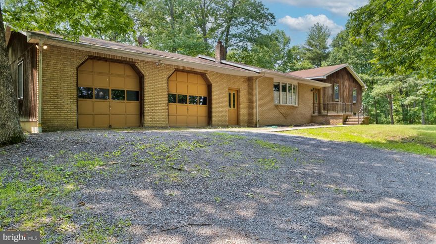 This unique listing is available for new owners to come make this home their own. Nestled on a sprawling 10.25-acre unrestricted lot, this exquisite bi-level residence exudes charm, sophistication and private living.  The exterior, a harmonious blend of brick and cedar, blends into the background well on this mostly wooded lot. This home really has it all, pull into the oversized garage with workshop space and additional storage. Step inside to discover a thoughtfully designed interior, with spacious mudroom/pantry area, the well-equipped kitchen and formal dining room, formal living room with beautiful custom built-ins, then step up to 3 spacious bedrooms with master bath and guest bath. Down the stairs you will find more custom built-ins on your way to what feels like a second home, the finished basement offers a large living room/recreational area with high ceilings and a wood burning fireplace, perfect for relaxing and entertaining. As you circle the basement there are a few flex rooms, currently set up as an office this space could be a fourth bedroom connected to a half bath with plenty of space to add a shower if desired. There's another large room and as you pass through you will find the utility area with a large storage space, laundry room and another flex room that has been used as a home gym in the past. This home is equipped with tankless water heater and a water treatment system and gas furnace. The French doors from the dining room open to the large rear deck. The shed and covered outbuilding are perfect for all of your extra tools and equipment. This property is not just a home; it’s a lifestyle, offering comfort, peace, space and nature at your doorstep. Must see this remarkable residence. Selling As-Is. Seller needs time to find another home and likely a short-term leaseback.