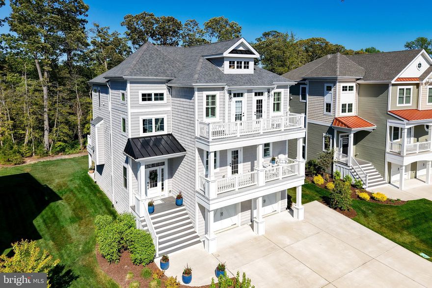 Experience coastal luxury at its finest in this exceptional, expanded Catalina model by Schell Brothers, perfectly positioned in the sought-after waterfront community of Tidewater Landing. Built in 2022, this 5-bedroom, 4.5-bath residence offers a thoughtfully designed floor plan masterfully tailored for both everyday comfort and high-end entertaining. The home’s three levels are seamlessly connected by a private elevator, ensuring effortless accessibility and convenience throughout. From the custom closet systems to the designer finishes and motorized blinds, plantation shutters, every detail has been curated to blend sophistication with functionality.  The heart of the home is the expansive open-concept main level. Here, a gourmet kitchen and dedicated dining area flow into a light-filled great room, all framed by peaceful views toward Love Creek. This level is designed for versatility, featuring a private guest suite with an attached bath, front balcony access, and a conveniently located powder room. The living space extends outdoors to a screened porch and deck, providing the perfect setting for relaxing coastal evenings.  The top floor serves as a dedicated residential retreat. The primary suite is a true sanctuary, boasting a spacious sitting area, dual walk-in closets, a spa-inspired bath, and direct access to a private upper-level deck overlooking the natural surroundings. Two additional generously sized bedrooms both with upper balcony access, a full bath, along with a conveniently located laundry room complete this level. The lower floor adds further depth to the home with a fifth bedroom, a full bath, and a large recreation room equipped with surround sound, ideal for movie nights or a home gym.  Outside, the large backyard provides a rare opportunity to create a private oasis with ample room for a future pool or outdoor kitchen backing to Love Creek, with Crabbing and Fishing in your own back yard!    The driveway is also expanded size for extra parking.  Located just moments from the community pier and kayak launch, this home delivers direct access to the water-centric lifestyle Tidewater Landing is known for. Situated perfectly between Lewes and Rehoboth Beach, you are steps away from world-class dining, shopping, and pristine Atlantic and Delaware Bay beaches.