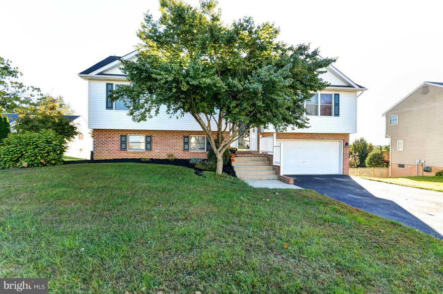 Enjoy your "deck" evenings with incredible views from the 12 x 26 deck as the sun sets to the front of the house. Split foyer with an open floor plan, cathedral ceilings, HW floors, finished lower level with 26 x 12 FR, built in book shelves, pellet stove, half bath, and sliders leading to a stamped concrete patio. Oversized 2 car garage and separate laundry. Nice landscaping.  About 2000 sq ft!