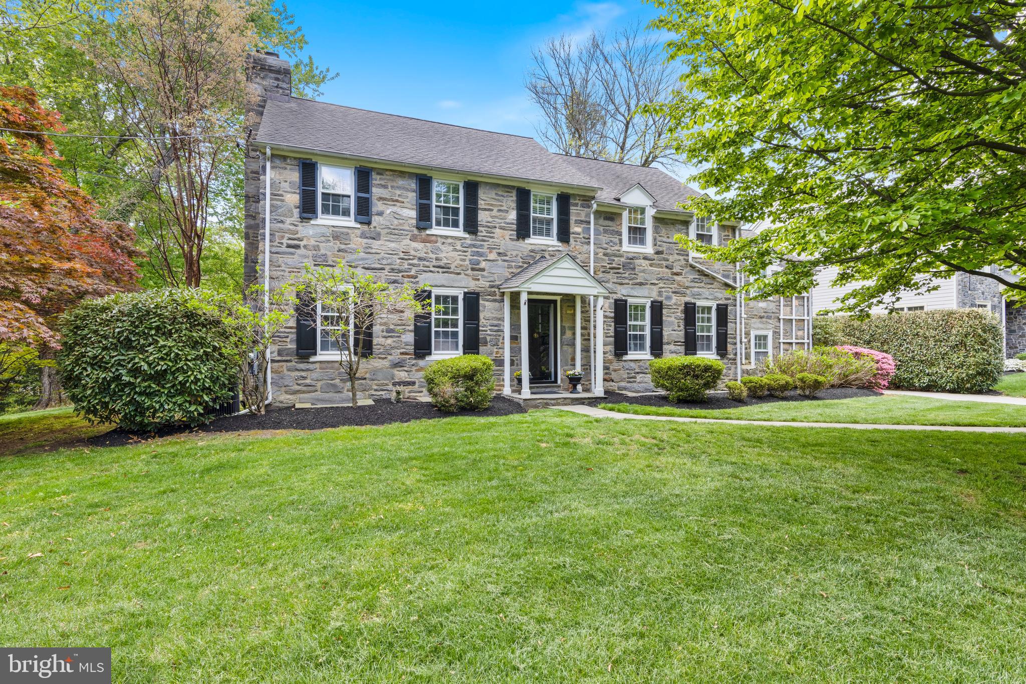 Welcome to 256 Hilldale Road, Villanova. Beautiful, classic stone colonial home situated on a picturesque tree lined street in the heart of Villanova, Radnor Township. This special home has been updated and meticulously maintained! Pull up to the stone wall front entrance and you will take note of the mature landscaping and specimen trees on this large level lot. Character abounds as you open the front door. Gleaming hardwood floors, center hallway, deep windowsills, crown mouldings and all the little details throughout tell you this is a house of stature and quality, a pre-war beauty. Off the center hall sits a large formal living room with classic built ins, beautiful mantle and wood burning fireplace. The formal dining room has 3 windows and plenty of room for hosting intimate dinner parties. Off the dining room and center hall is the updated kitchen. White cabinets, quartz countertops, farmhouse sink, stainless appliances, wall ovens, and a double window looking onto the backyard complete the kitchen. Side step the kitchen to a step down family room and backsteps. The hardwood floors continue into the family room with a large bay window and built in shelves and cabinetry. The kitchen also has a large pantry and is open to the breakfast room. With pendant lighting, this room hosts a large table and has French doors out to the expansive backyard. An additional bedroom with double closets and large full bath with double sink completes the first floor. This bedroom could also be used as an in-law suite, au pair suite or separate office. The second floor boasts 5 bedrooms and 3 updated full bathrooms. The hardwood floors, the mouldings, deep windowsills and character continues upstairs. The primary bedroom has 3 closets and access to the primary bath and bedroom #2, which is currently used as an office. Bedroom #3 and #4 share a jack n jill bath. Step down to bedroom #5 which is off the backstairs as well and has private access to bathroom #3. In addition is large cedar closet for storage. The basement is large and unfinished with lots of potential plus a fireplace. The two car, oversized detached garage has covered side area for grilling and seating. The backyard opens to the lush and expansive flat lot, this is truly one of a kind in Radnor Township! Walking distance to all that Villanova has to offer, the University, Villanova Train Station, restaurants, shops, gym and yoga studios. As well as quick and easy access to major highways to head to the city, the airport, the shore or where ever you might head. Top rated Radnor School District, and close proximity to many private school options. Make your appointment today!