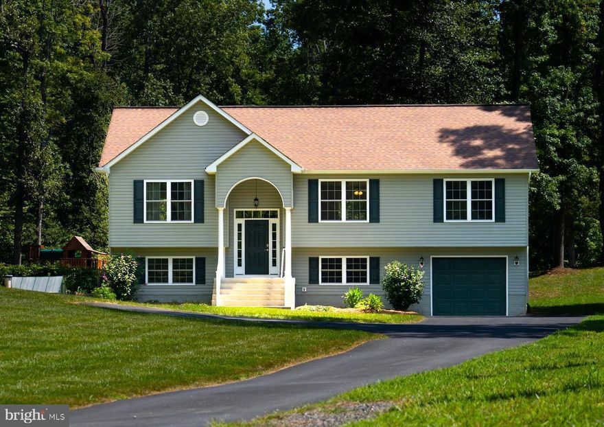 Country living at its best! The grounds that surround this beautiful home are full of fruit trees, gardens, trails, trees, and open space for endless outdoor fun.  4/5 Bedrooms, 3 baths, living room with vaulted ceilings, eat in kitchen with granite countertops and stainless steel appliances , dining area leading to the deck and large family room.  Primary bedroom suite with walk in closet and bathroom.  Attached garage.  Detached metal storage building with two oversized garage doors is located on the rear of the property.  Small green house.  Chicken coop. Ample parking with asphalt driveway and gravel parking area, generator hookup. This property has endless options for you!