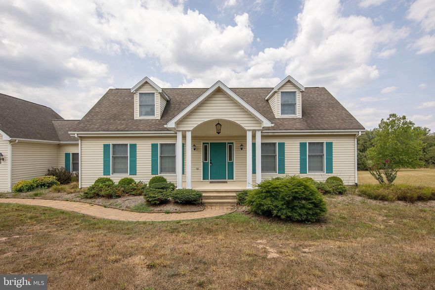 This charming Cape Cod-style home features two stories and boasts over 1,800 square feet of well-designed living space. The main floor includes a spacious primary suite with a large walk-in closet, a separate shower, and a luxurious soaking tub. Conveniently located on this level, the main half  bathroom is equipped with a washer and dryer for added ease.

The heart of the home is the expansive kitchen, complete with a wall oven, gas stovetop, dishwasher, and ample cabinet space. An adjacent dining area provides a perfect space for family gatherings, while a cozy sitting area connects the garage to the kitchen, enhancing the home’s charm. A large living room and a welcoming foyer complete the main level.

Upstairs, you'll find two additional large bedrooms and a full bathroom, providing plenty of space for family or guests. The home features dual-zone heating and air conditioning for year-round comfort.

Set on a quiet road with no through traffic, this property is beautifully landscaped to complement the home. It’s ideally located just 45 minutes from Winchester, VA, and a short drive to Washington, D.C., making it perfect for those who want a peaceful retreat with easy access to city amenities. An unfinished basement and a two-car attached garage add to the home's excellent features and layout.