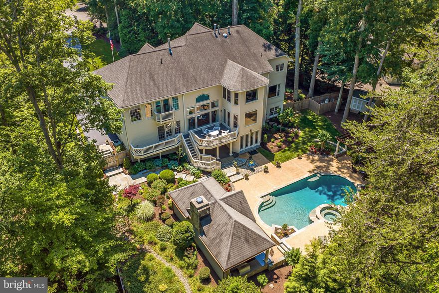 Exceptional and truly one-of-a-kind, this Fairfax Station estate offers more than 7,000 square feet of refined living, unmatched upgrades, and resort-style outdoor spaces. With over $1.5 million invested in renovations since purchase, this rare property shows like a model and delivers an extraordinary blend of elegance, comfort and flexibility. ***** The main residence features an open, light-filled floor plan with beautifully updated interiors, including newer interior paint, rich hardwood flooring, extensive custom moldings and Amish-built custom cabinetry. Elegant formal living and dining rooms create a sophisticated setting for gatherings, while the expansive family room opens seamlessly to the remodeled chef’s kitchen for effortless everyday living and entertaining. The kitchen is appointed with a Wolf range, Samsung French door refrigerator, wine fridge, granite countertops, and a beautiful connection to the stunning two story family room with a statement fireplace and stone detail ****** The upper level offers four spacious bedrooms and three full baths, including a luxurious primary suite with a sitting area, romantic fireplace, two walk-in closets, and a fully remodeled spa bath. A private princess suite and a Jack and Jill bathroom complete the upper level. The fully finished walkout lower level is truly exceptional, featuring high-end flooring, custom Amish millwork, built-in gas lanterns, and a designer wet bar with granite countertops, an additional refrigerator, and a dishwasher. A dedicated wine room, full bath with steam shower, private gym, and pool changing room add both function and sophistication creating a lower level designed for relaxation, entertaining, and everyday enjoyment. ****** Outdoor living is just as impressive, with beautifully designed grounds enhanced by high-end LED low-voltage lighting and a Wi-Fi controlled irrigation system. The backyard oasis features an in-ground pool with heated spa, expansive slate and concrete hardscaping, and a fully equipped outdoor kitchen with dual refrigerators, fireplace, ceiling fans, and generous dining and entertaining areas designed for year-round enjoyment. ****** A standout feature of the property is the attached addition with an additional 5th full bath, offering incredible flexibility as a club room, private office, guest suite, multigenerational living space, or potential income-producing opportunity. The expanded four-car garage is a car enthusiast’s dream, complete with separate heating and cooling, recently resurfaced epoxy floors, and custom built-ins, and abundant. Additional highlights include a newer 75-gallon hot water heater installed in 2020, a freshly painted exterior, updated interior paint, and a newer fence. Rarely does a property offer this level of space, quality, thoughtful renovation, and resort-style living in such a coveted Fairfax Station setting.