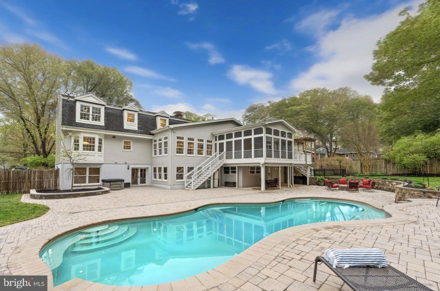 Wow! You have to see this stunning home! A true gem tucked away in the sought-after neighborhood of Homewood, this one-of-a-kind home offers an exceptional opportunity for multigenerational living, with a rare main level primary bedroom and additional primary bedroom upstairs. Experience the ultimate in luxury and comfort with an amazing in-ground pool and gorgeously landscaped outdoor space on nearly one acre of land. From the moment you step onto the idyllic front porch, you’ll be captivated by the home’s elegant charm and exceptional craftsmanship. Once inside, you’ll discover a magnificent home that is much more expansive than it appears! The main level showcases an open floorplan with gleaming refinished hardwood floors, fresh paint, recessed lighting, and abundant natural light. Both the formal living room and dining rooms are adorned with large picture windows and elegant crown and chair rail molding. The on-trend kitchen has been recently updated with two-tone cabinets, sleek granite countertops, and stainless steel appliances, including a brand new double oven and gas range. The peninsula breakfast bar opens the space directly into the sunroom, where built-in bookshelves, a gas fireplace, and a wall of windows create a warm, inviting atmosphere. On this side of the home, discover the rare and luxurious main level primary bedroom, with a sophisticated tray ceiling, private office nook, and a massive walk-in with custom closet system. The elegant en suite bathroom is generously sized and boasts a handsome vanity, step-in shower, and soothing soaking tub. For your convenience, the first large laundry room is also included here. Rounding out this level of the home is the cozy family room, featuring an impressive stone surround fireplace and wooden ceiling beams. Upstairs, the second primary bedroom suite awaits, with plush carpeting, a large walk-in closet, and its own stylish bathroom with contemporary finishes. Both additional bedrooms on this level include soft carpet and wide closets, with shared access to the modern full bathroom in the hall. The fourth upstairs bedroom has been converted into a large second laundry room, and could easily be converted back to a bedroom in order to suit your needs. Versatile spaces abound on the lower level of the home, with an expansive recreation room, large storage room, and multiple flexible spaces for a playroom, home gym or game room. Through the french doors, enjoy the beautiful view of your backyard retreat with wall-to-wall windows in the lower level sunroom. You’ll also find two additional bedrooms with a fourth full bathroom on this level, making it an ideal private space for guests or a home office. The screened-in porch, deck, and fully fenced backyard offer you a personal oasis, surrounded by trees and beautiful landscaping as you splash around in your in-ground pool and entertain on the.expansive brick patio. The three car garage and long driveway provide you with an abundance of parking for you and your visitors. Enjoy the comfort and efficiency of the three-zone HVAC system all year long! Just minutes to Whole Foods, Giant Food, Lidl, H-Mart, West Springfield Shopping Center, Burke Village Center, Lake Accotink and Burke Lake Parks, Springfield Golf & Country Club, and Hidden Pond Nature Center. Quick access to Burke Lake Road, Fairfax County Parkway, Braddock Road, Ox Road. I-395, I-95, I-495, and the Rolling Road VRE Station conveniently located at the end of the street!! In the desirable Lake Braddock school pyramid, this gorgeous home won’t last long. Schedule a private tour and enjoy every moment of the Summer in your new home!