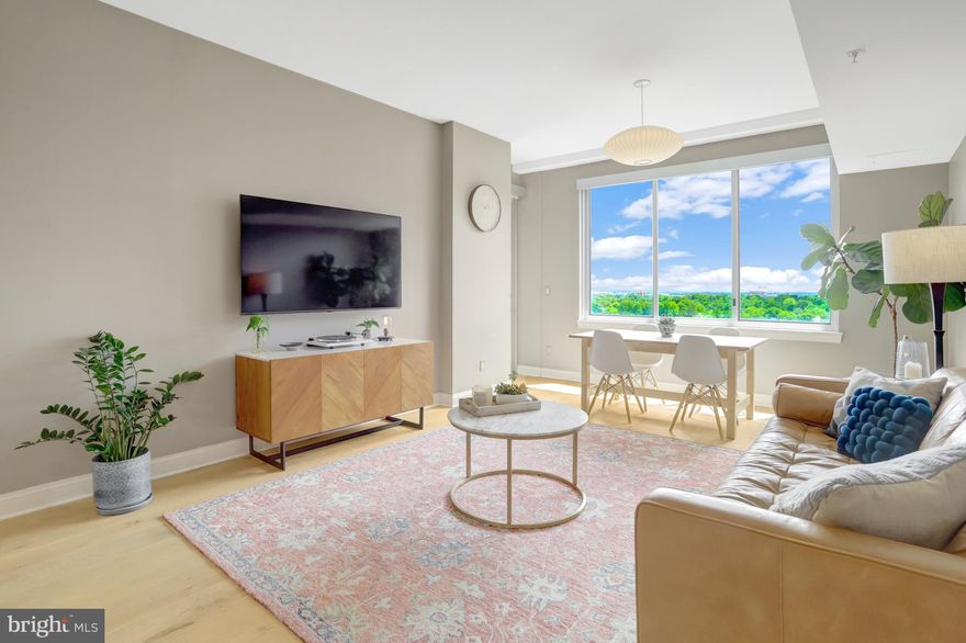 Step into elevated living with this exceptional PENTHOUSE apartment at The Phoenix, one of Clarendon's most sought after residences. Spanning 1,088  sq ft of finished space, this stunning two-bedroom, two-bathroom home features high ceilings, wide-plank wood flooring, and unobstructed southern views. The open-concept living and dining area is generously sized, anchored by floor-to-ceiling windows that create an airy, light-filled ambiance—ideal for both relaxing and entertaining. The gourmet kitchen impresses with brand-new stainless steel appliances—perfect for both everyday living and hosting. The primary suite boasts a well appointed en-suite bathroom, custom closet organizers for seamless storage, and access to a private balcony through oversized sliding glass doors. A second bedroom with ample storage, and an additional full bathroom provide flexibility for guests or a home office. Additional features include an in-unit washer and dryer, whole-house water filtration system, two private parking spaces equipped with dedicated electric vehicle charging, and a separate storage unit. Enjoy the convenience of concierge service and premium building amenities in one of the area's most desirable addresses. Just two blocks from the Clarendon Metro station, this premier residence offers seamless access to Washington, D.C., and the entire DMV region. The Phoenix features an array of luxury amenities, including a rooftop pool with sweeping views, a modern fitness center, resident library, theater room, business center, and a tranquil courtyard. Step outside and enjoy walkable access to top-rated restaurants, cafés, Whole Foods, Trader Joe’s, and the stylish boutiques at The Crossing Clarendon. With its unbeatable location and exceptional lifestyle offerings, The Phoenix is the perfect place to call home in Northern Virginia.